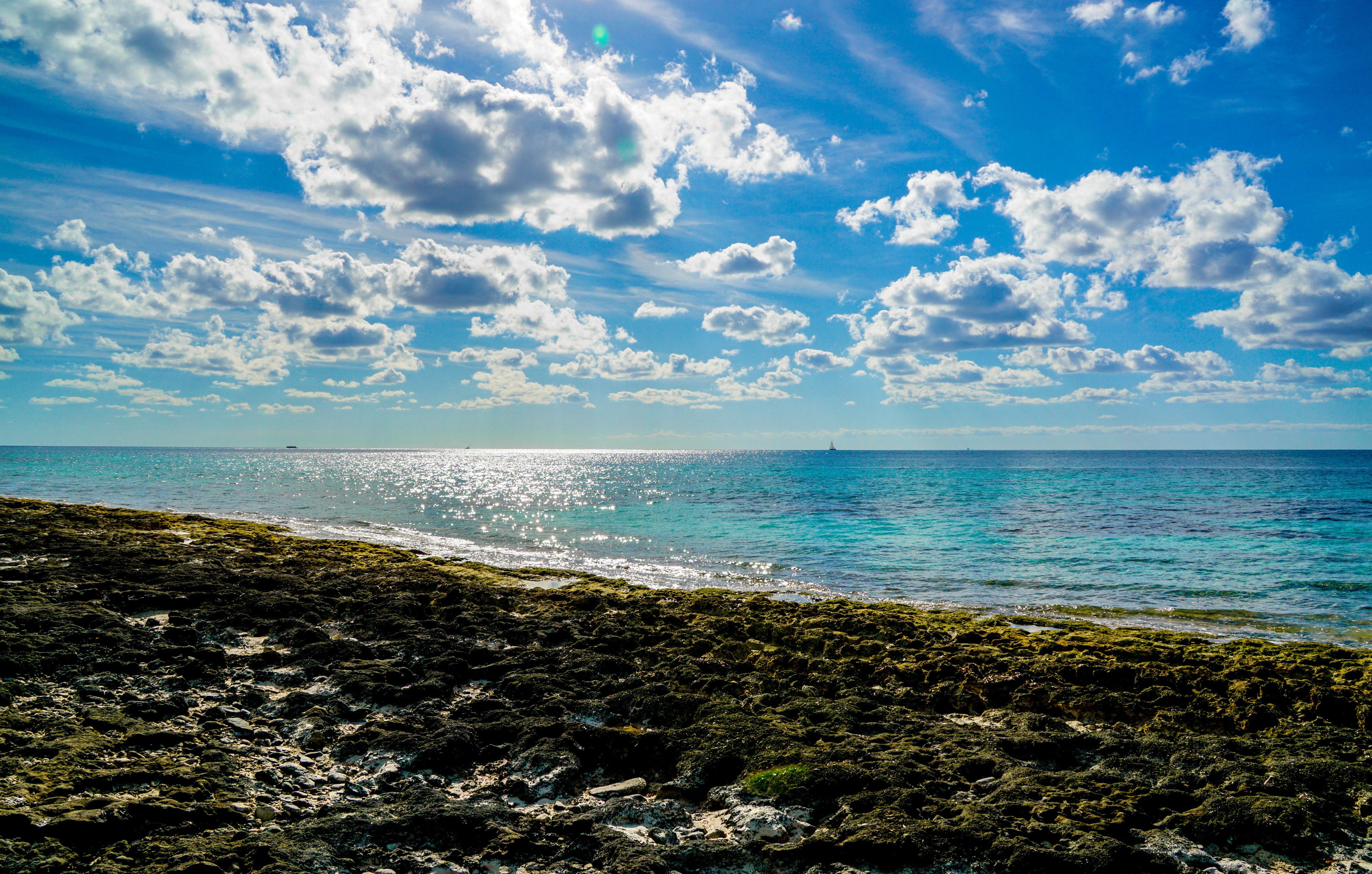 Sea Coast with Clouds and Sun Reflection HD Wallpaper