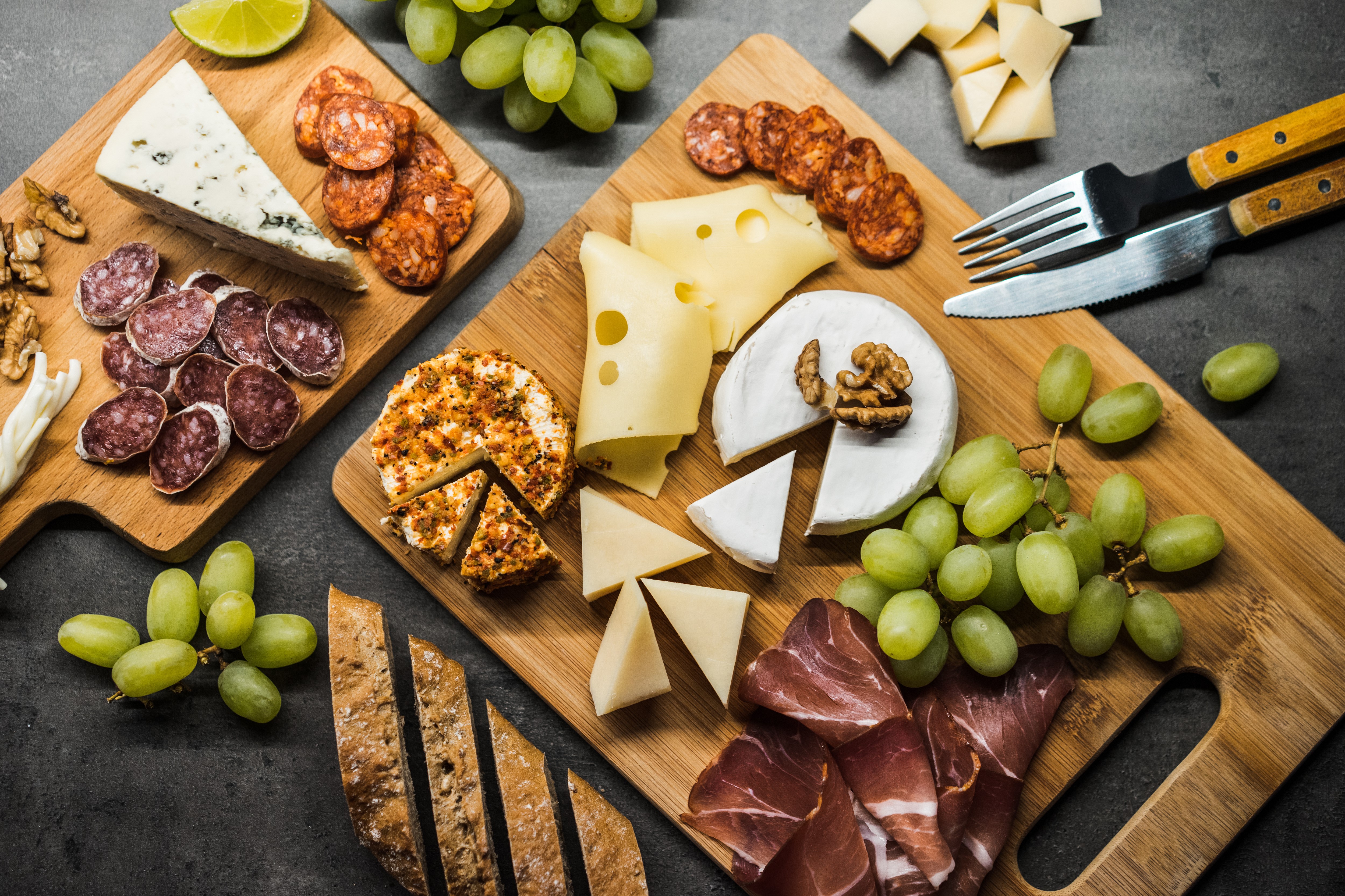 Cheese and Sausage Platter with Grapes and Bread HD Wallpaper