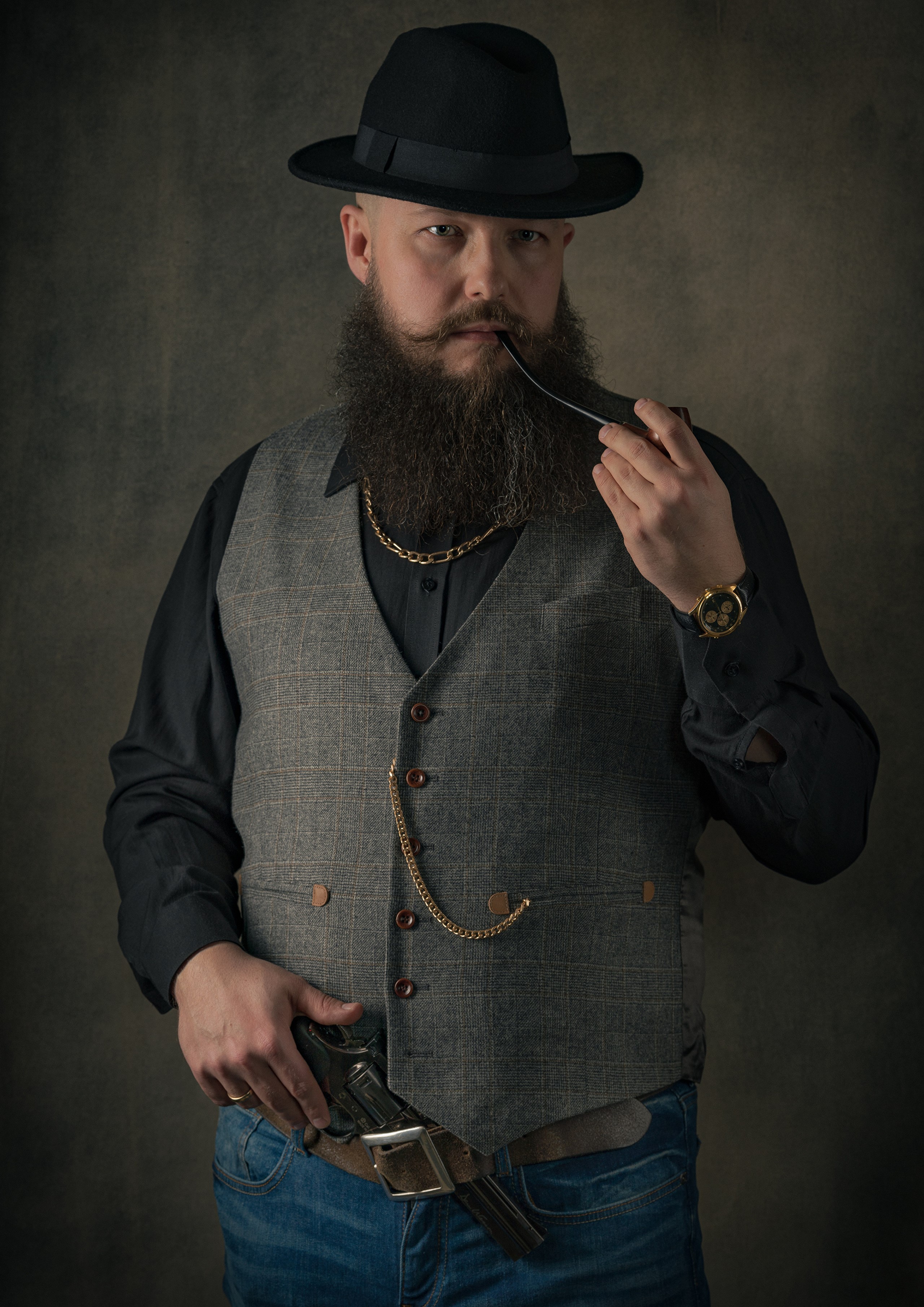 Man with beard, hat, vest, and pistol HD Phone Wallpaper