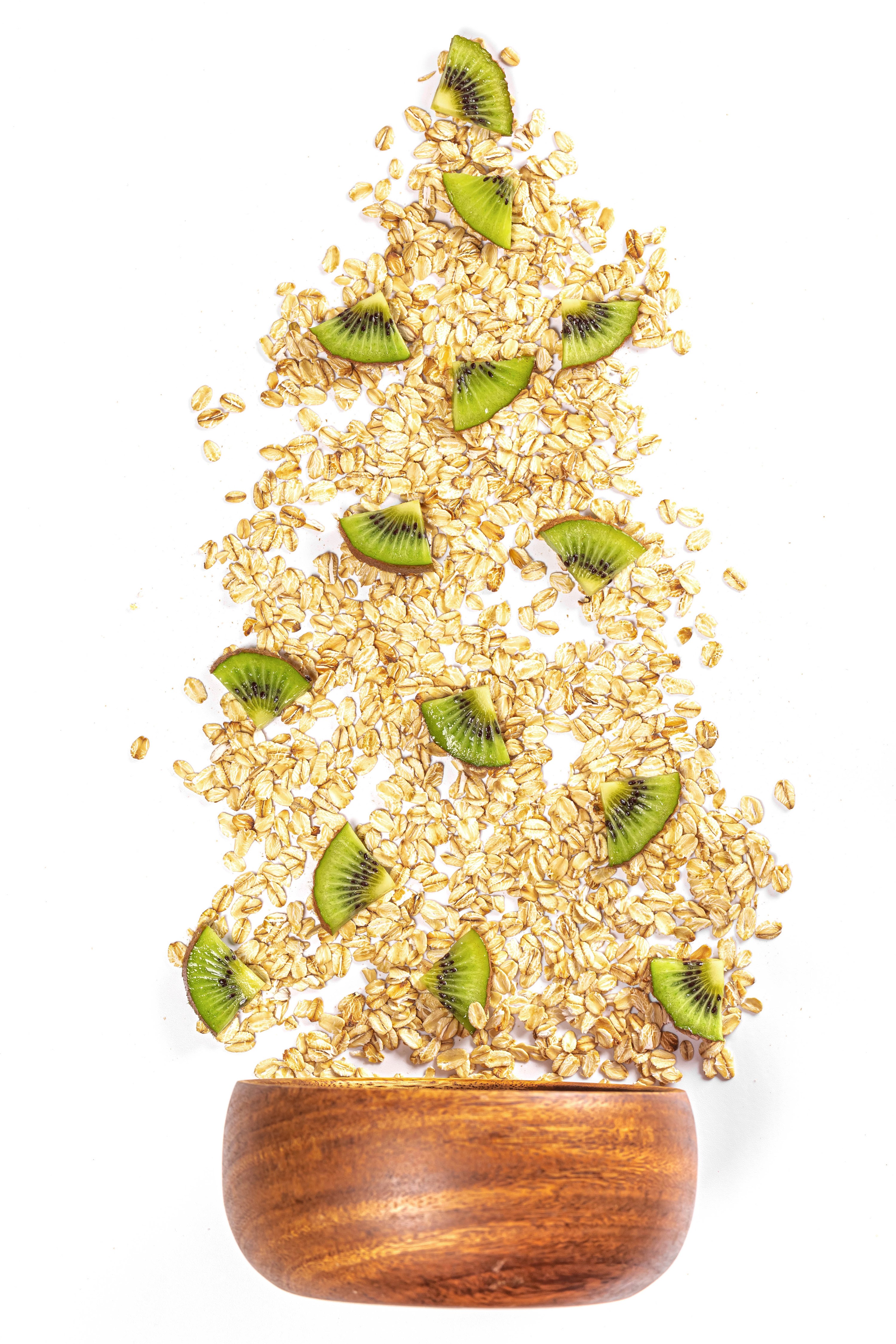 Oatmeal and kiwi slices scattered on a white background HD Phone Wallpaper