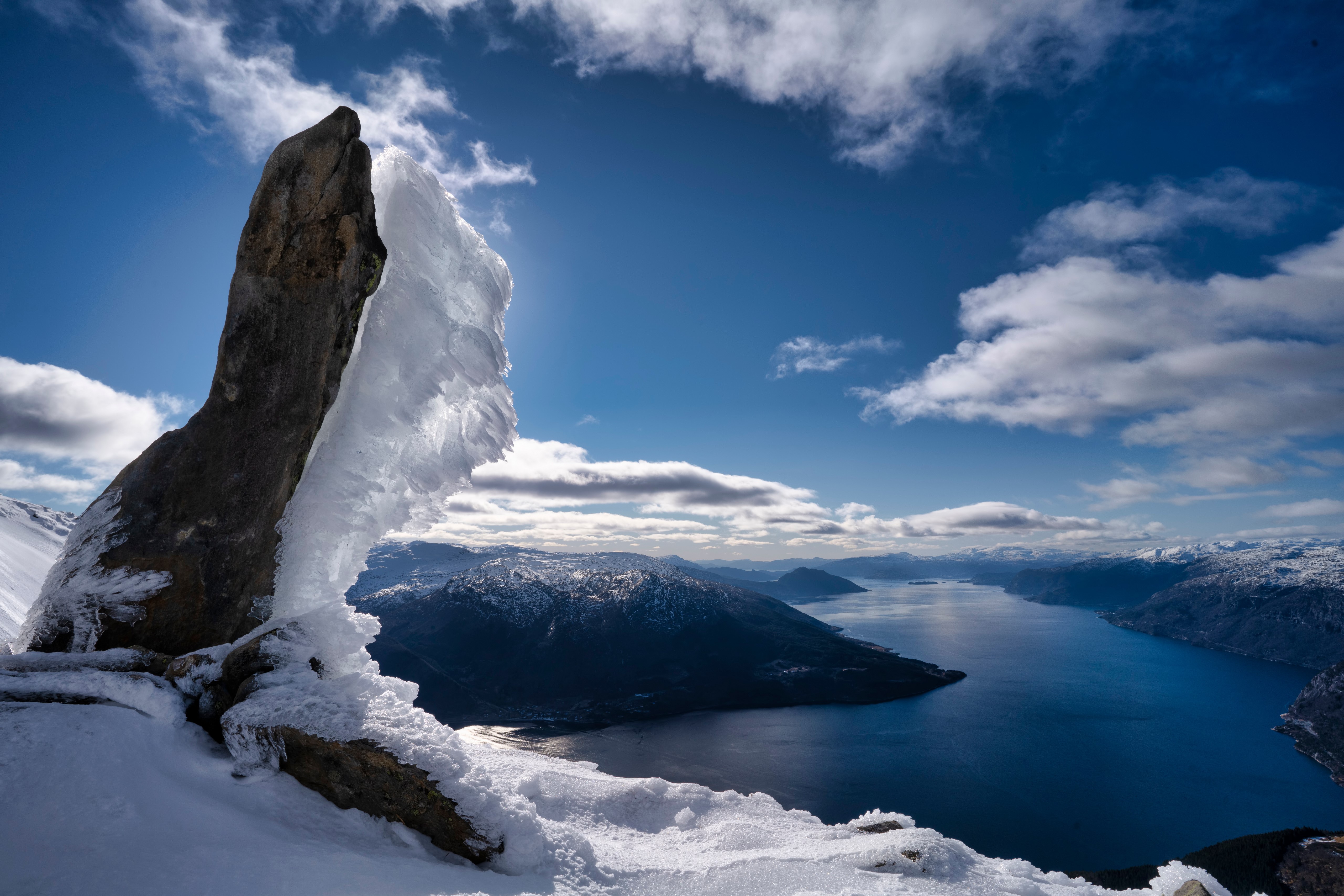 Snowy Crag overlooking a Fjord in Norway HD Wallpaper