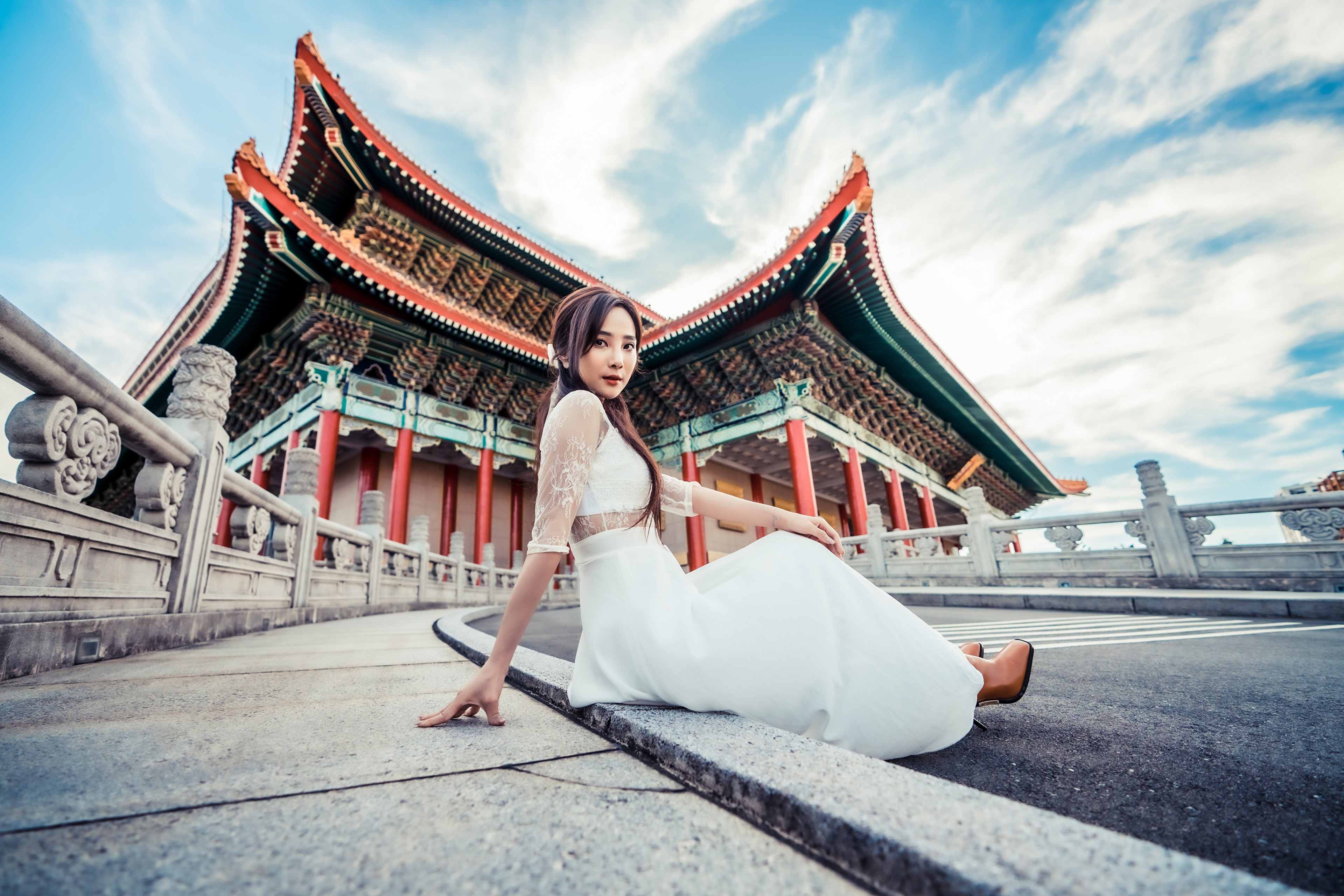 Asian woman in white dress sitting near traditional building HD Wallpaper