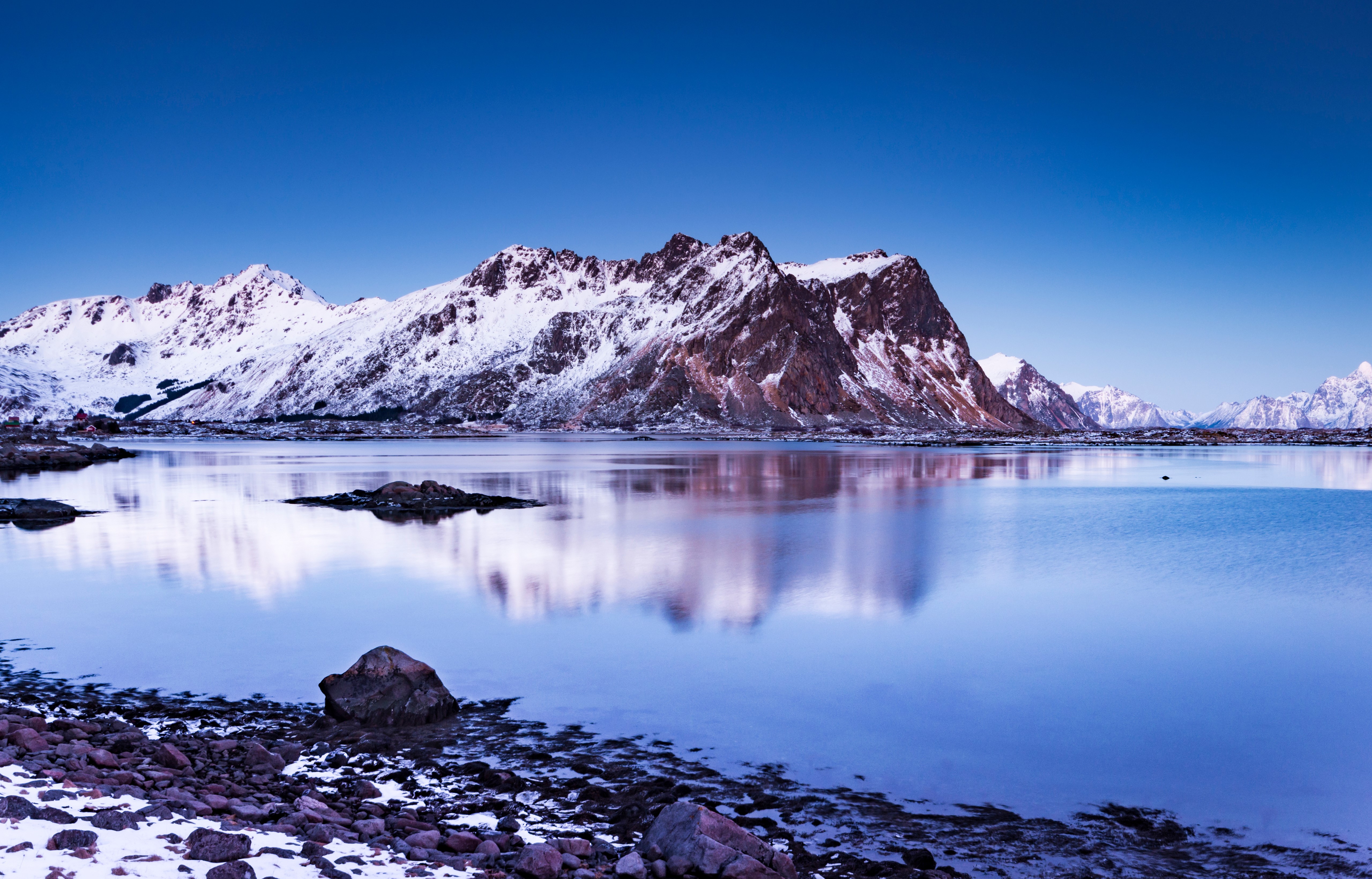 Snowy Lofoten Mountains reflected in calm water, Norway HD Wallpaper