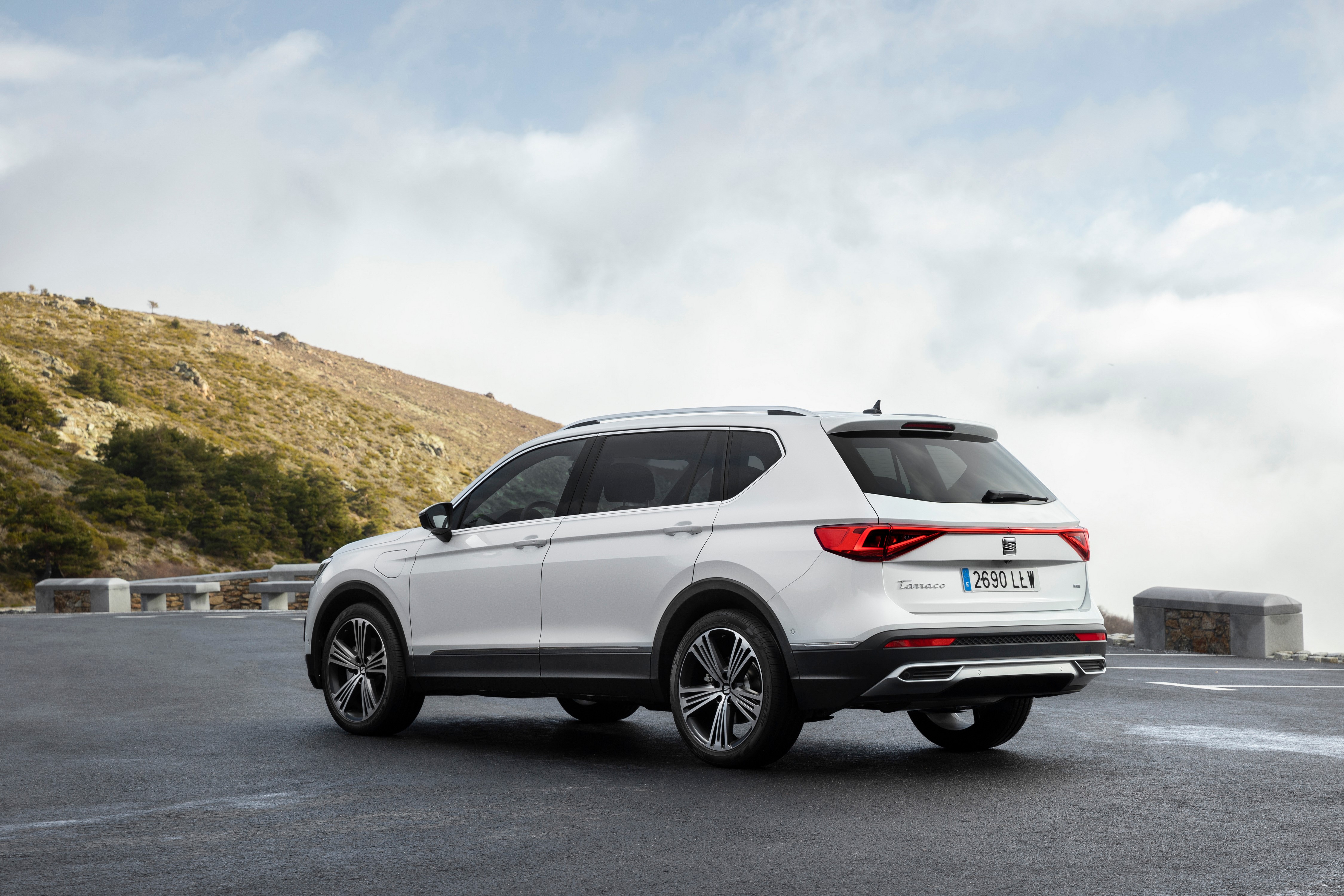 White Seat Tarraco eHybrid parked on a mountain road HD Wallpaper
