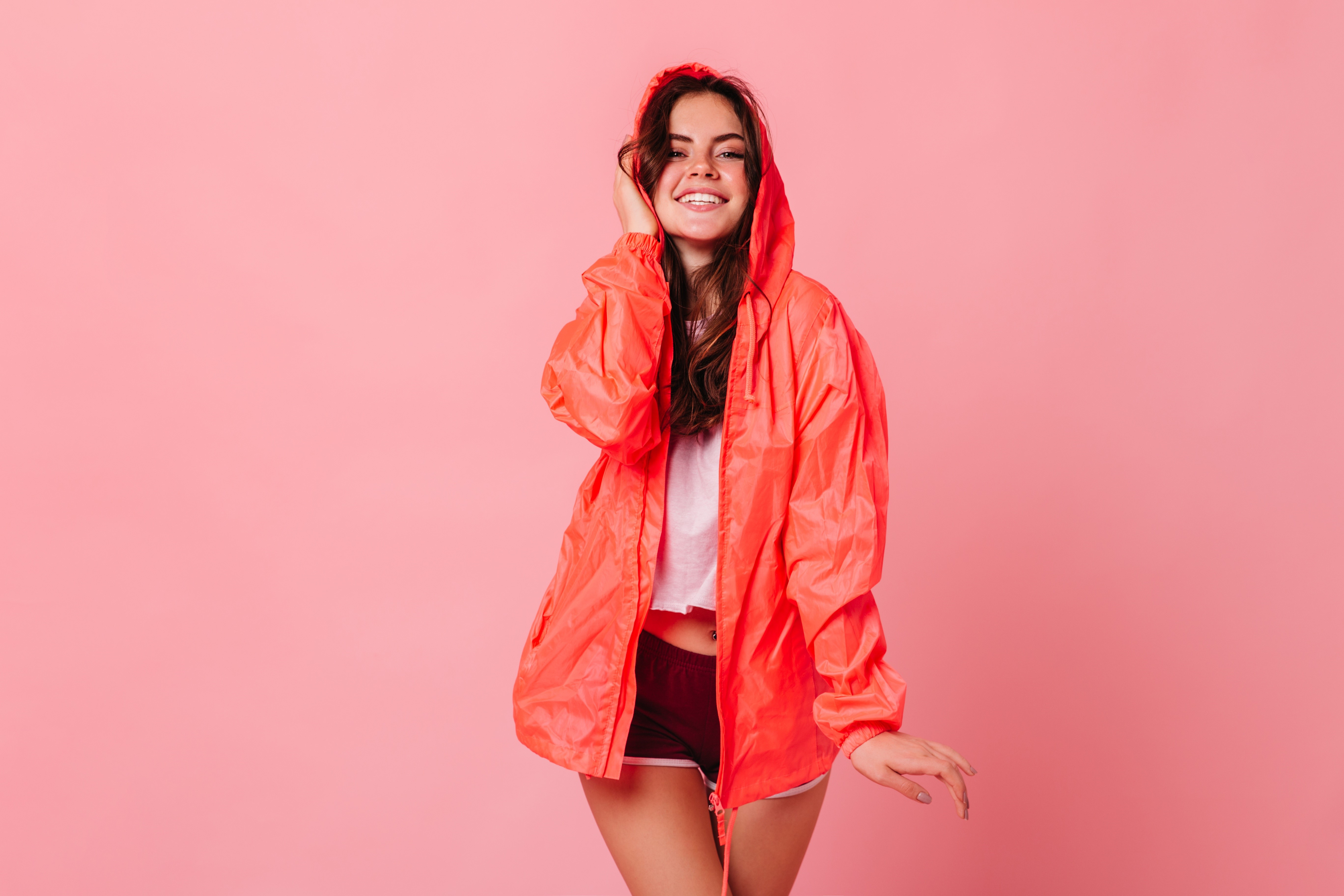 Woman in orange hooded jacket and shorts HD Wallpaper