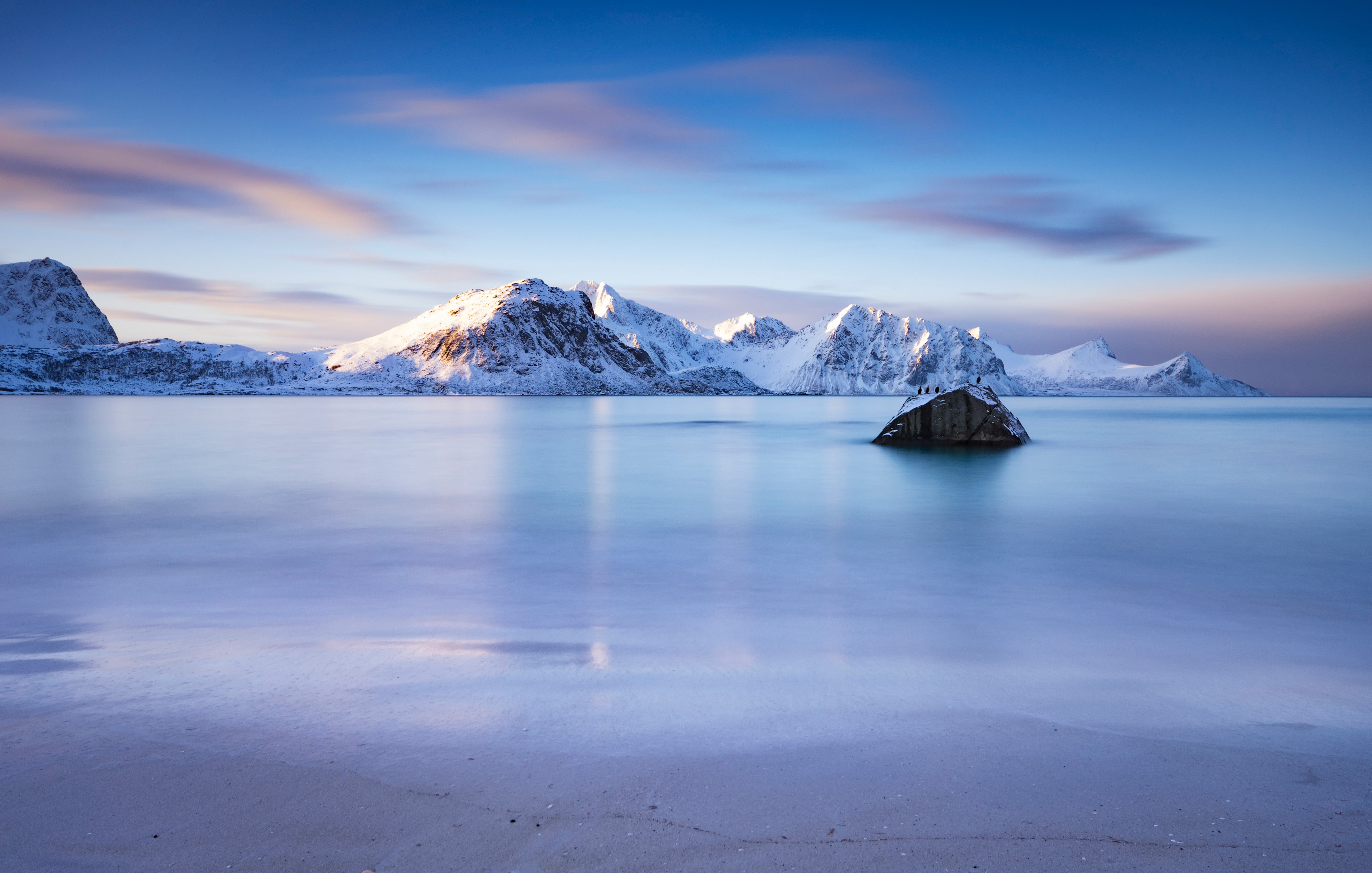 Snowy Mountains and Calm Sea at Haukland Beach, Lofoten, Norway HD Wallpaper