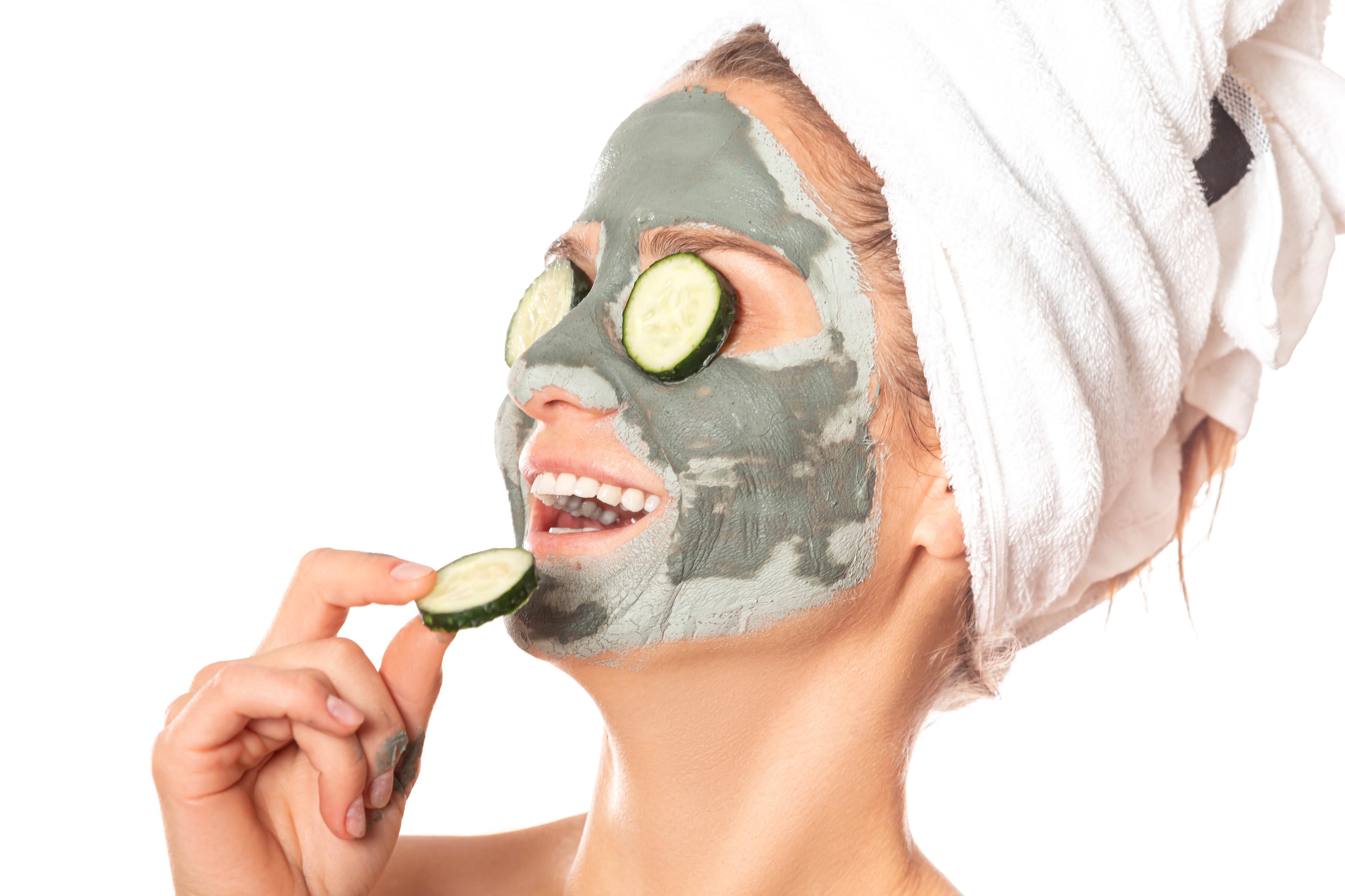 Woman with mud mask and cucumber slices HD Wallpaper