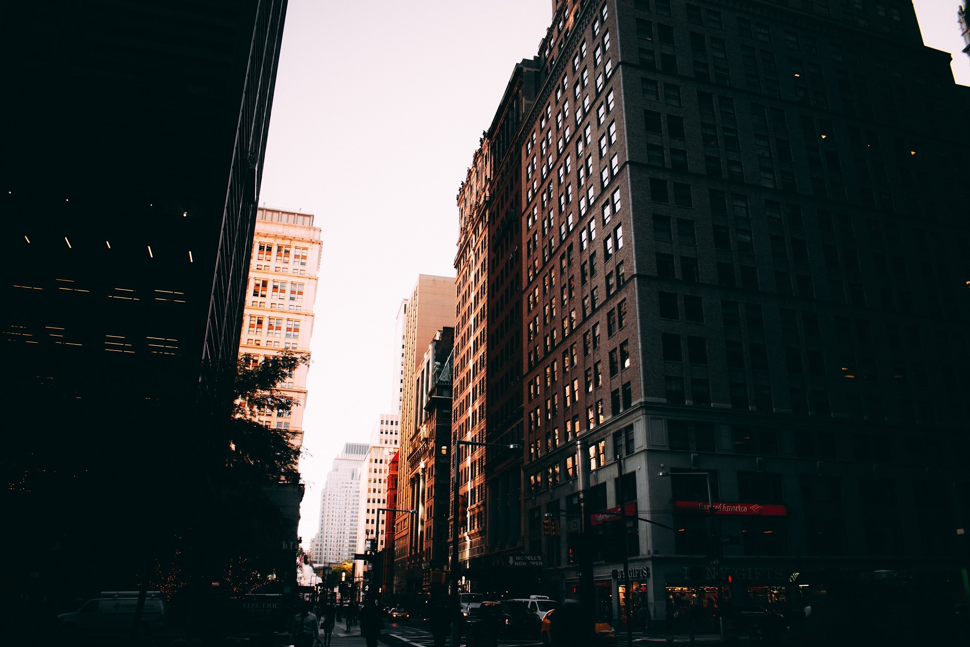 City street with tall buildings at sunset HD Wallpaper