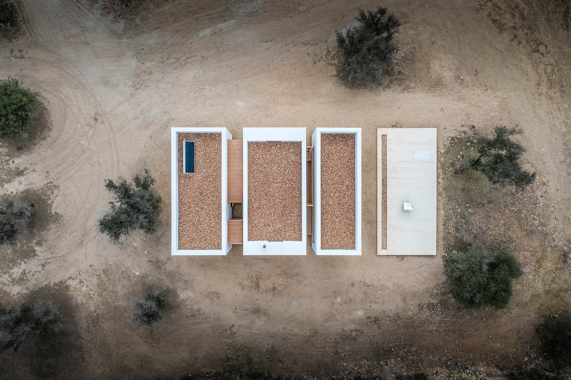 Aerial view of a modern house with flat, gravel rooftops HD Wallpaper
