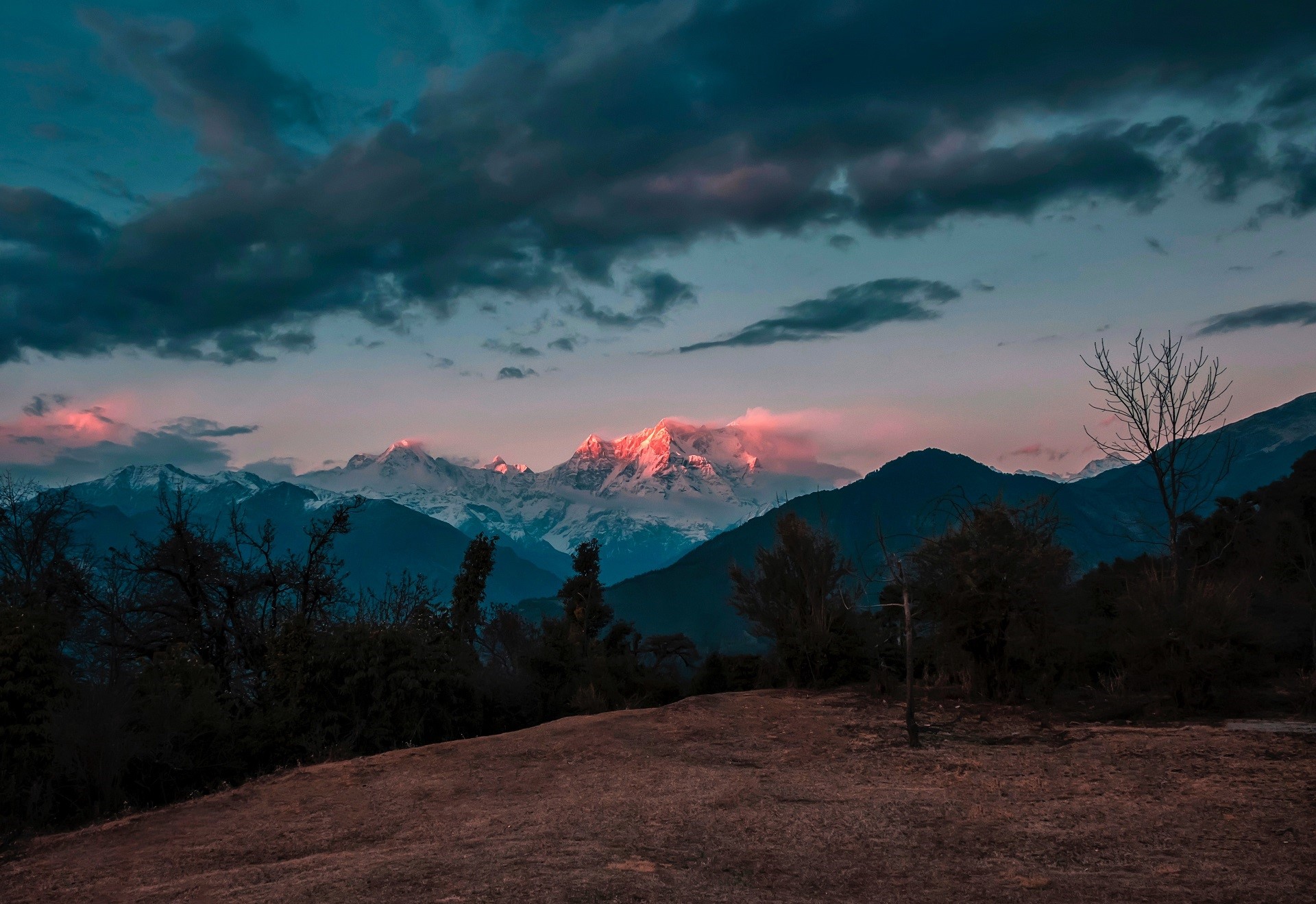 Snowy mountains at sunset with clouds HD Wallpaper