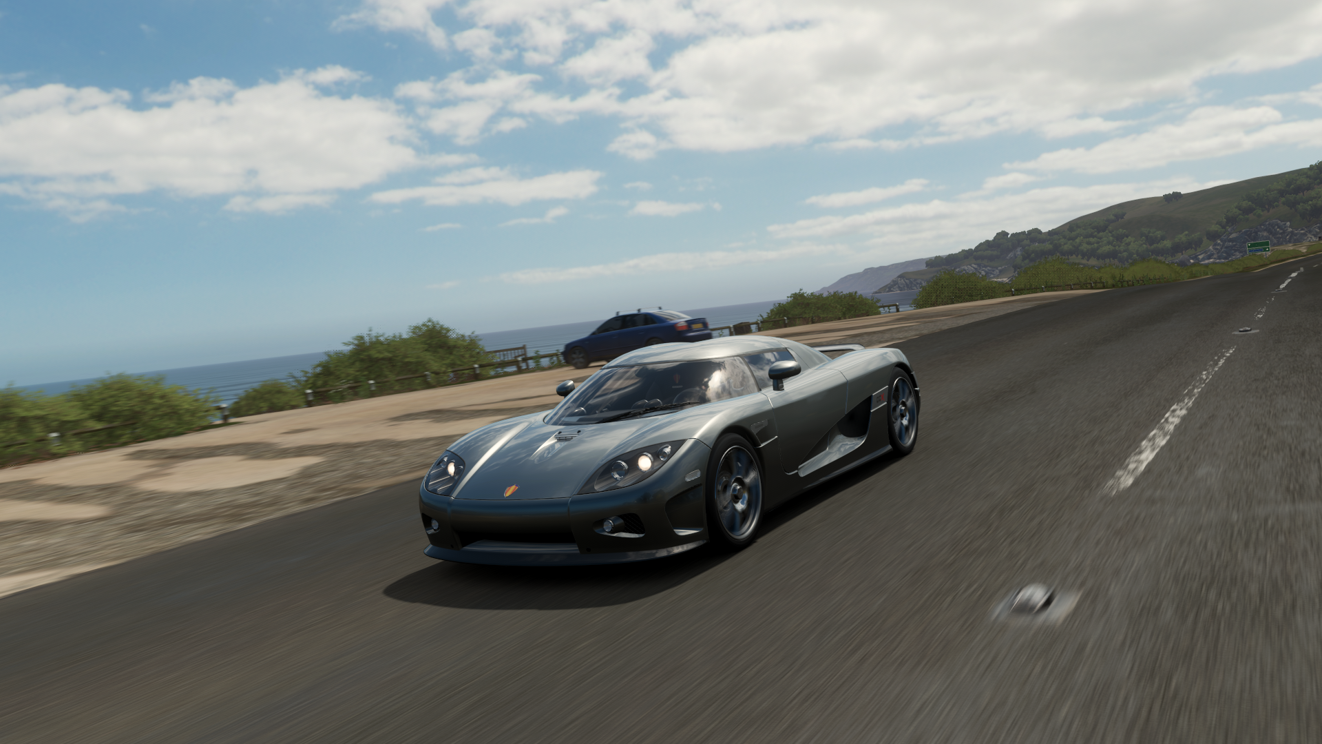 Koenigsegg CCX driving on a coastal road in Forza Horizon 4 HD Wallpaper