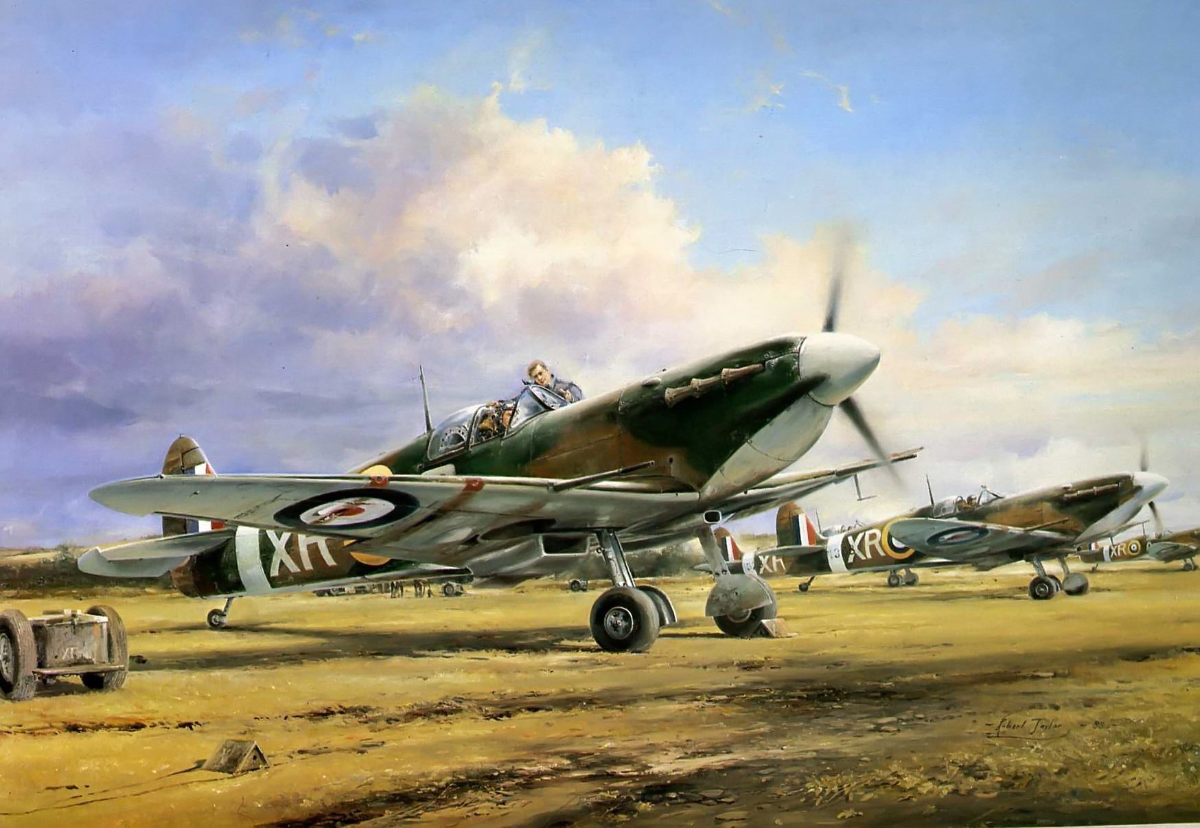 Supermarine Spitfires on a grassy airfield HD Wallpaper