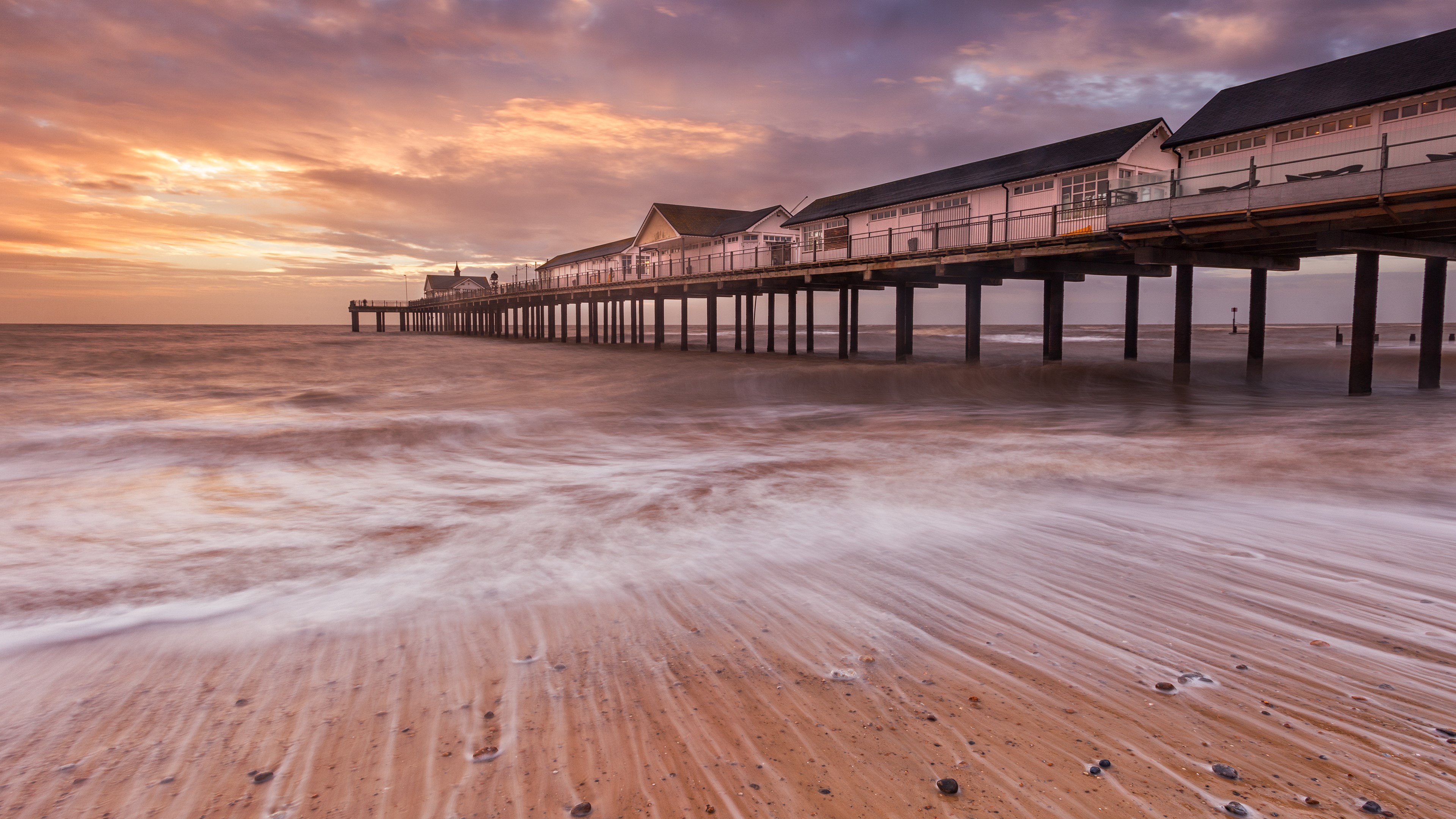 Pier over the ocean at sunset HD Wallpaper