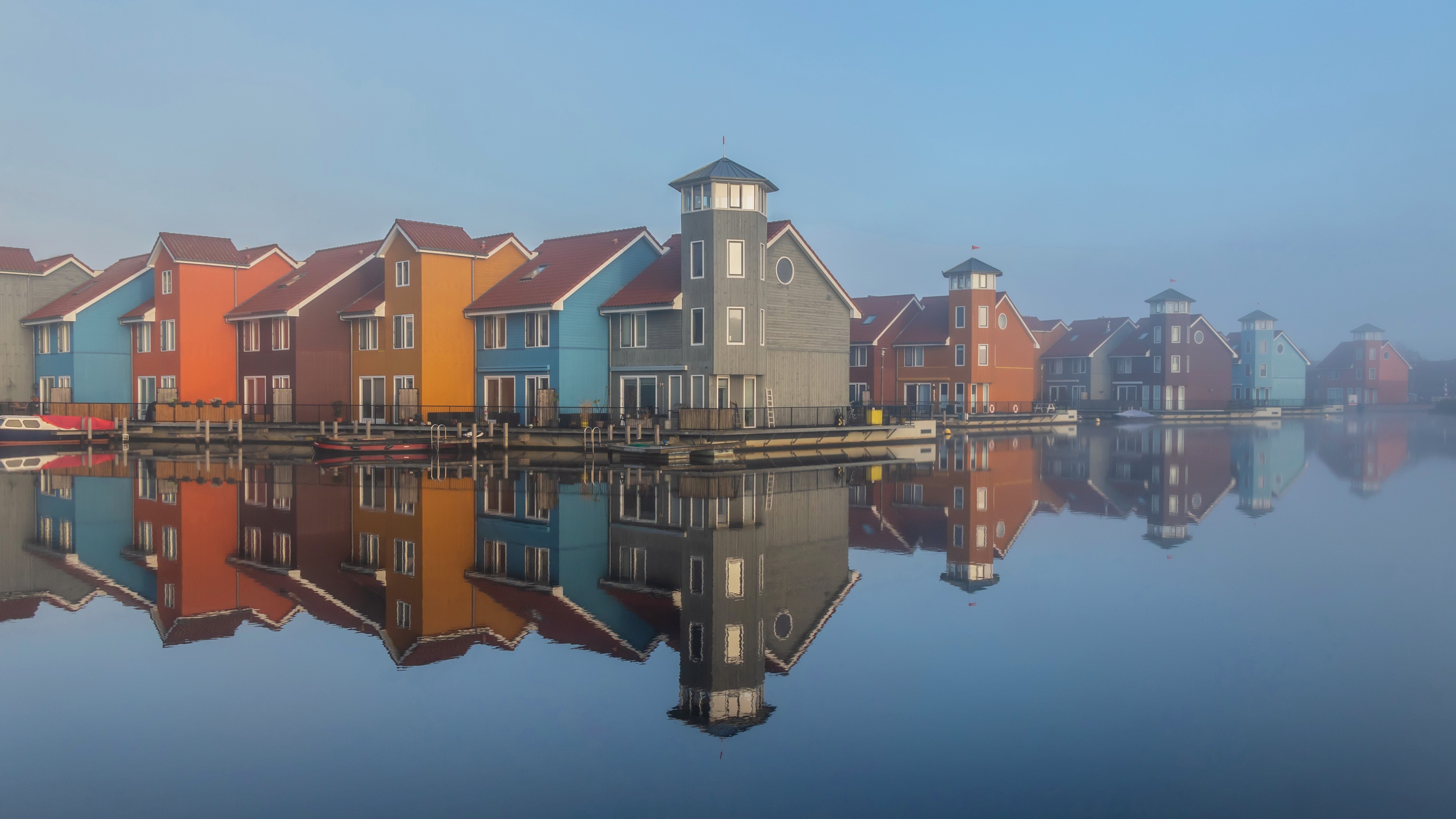 Colorful houses on water with reflections HD Wallpaper