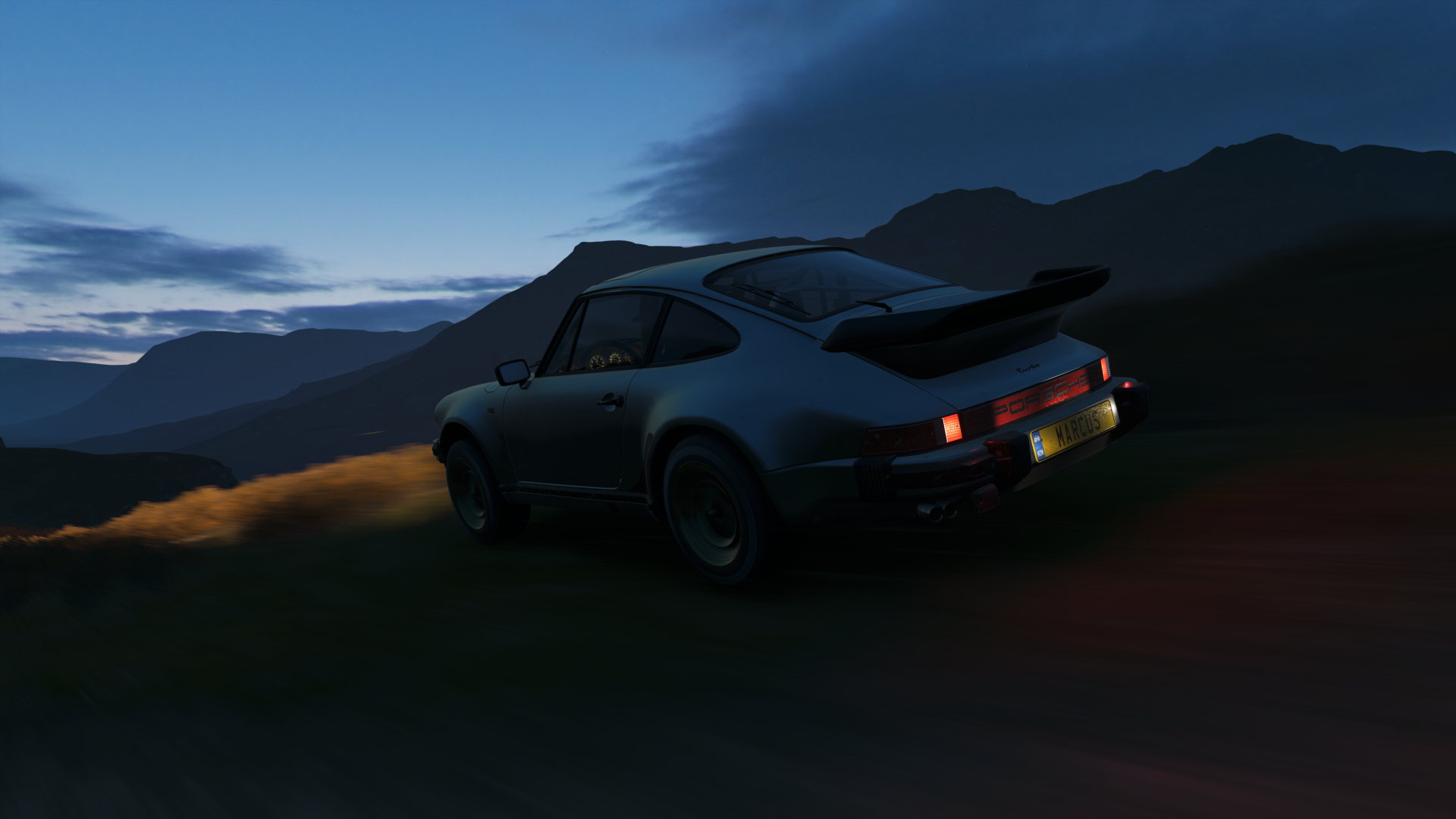 Porsche 911 Turbo driving on a mountain road at dusk HD Wallpaper