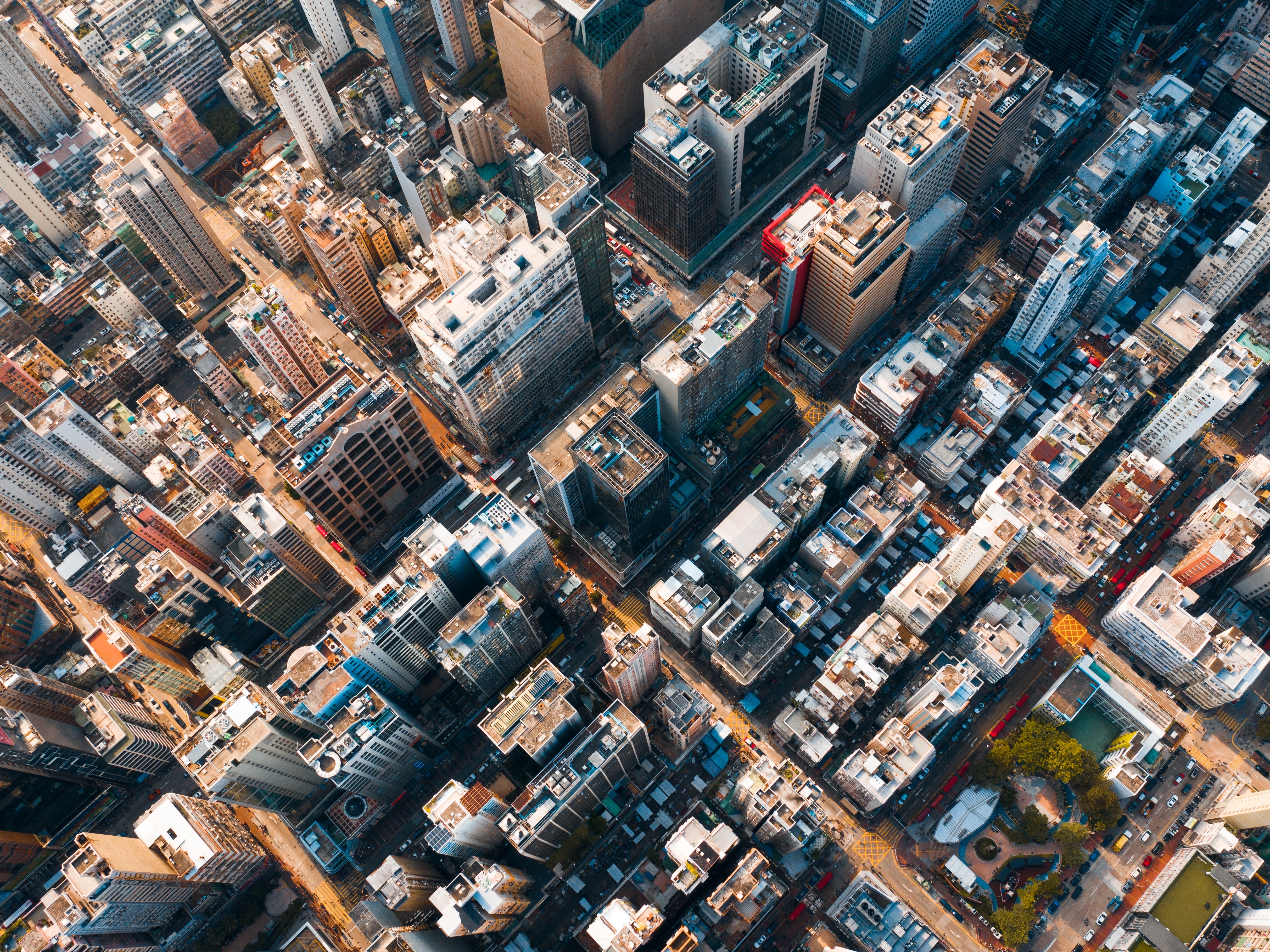 4K aerial view of a dense urban city with tall buildings HD Wallpaper