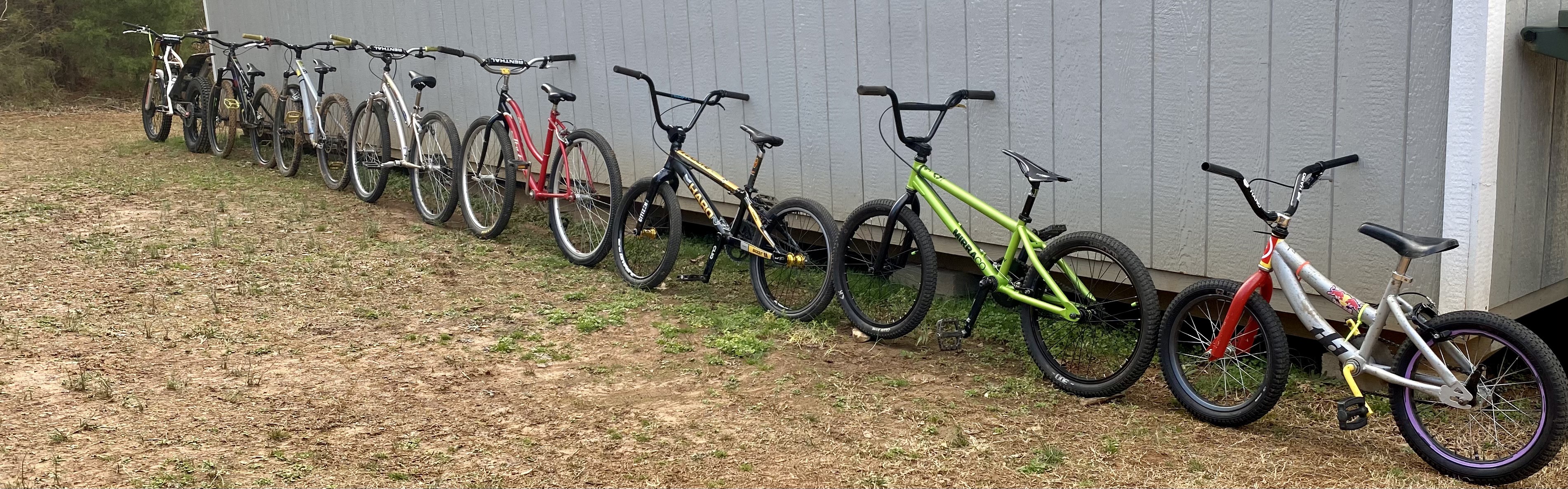 Collection of BMX bikes lined up outdoors HD Wallpaper