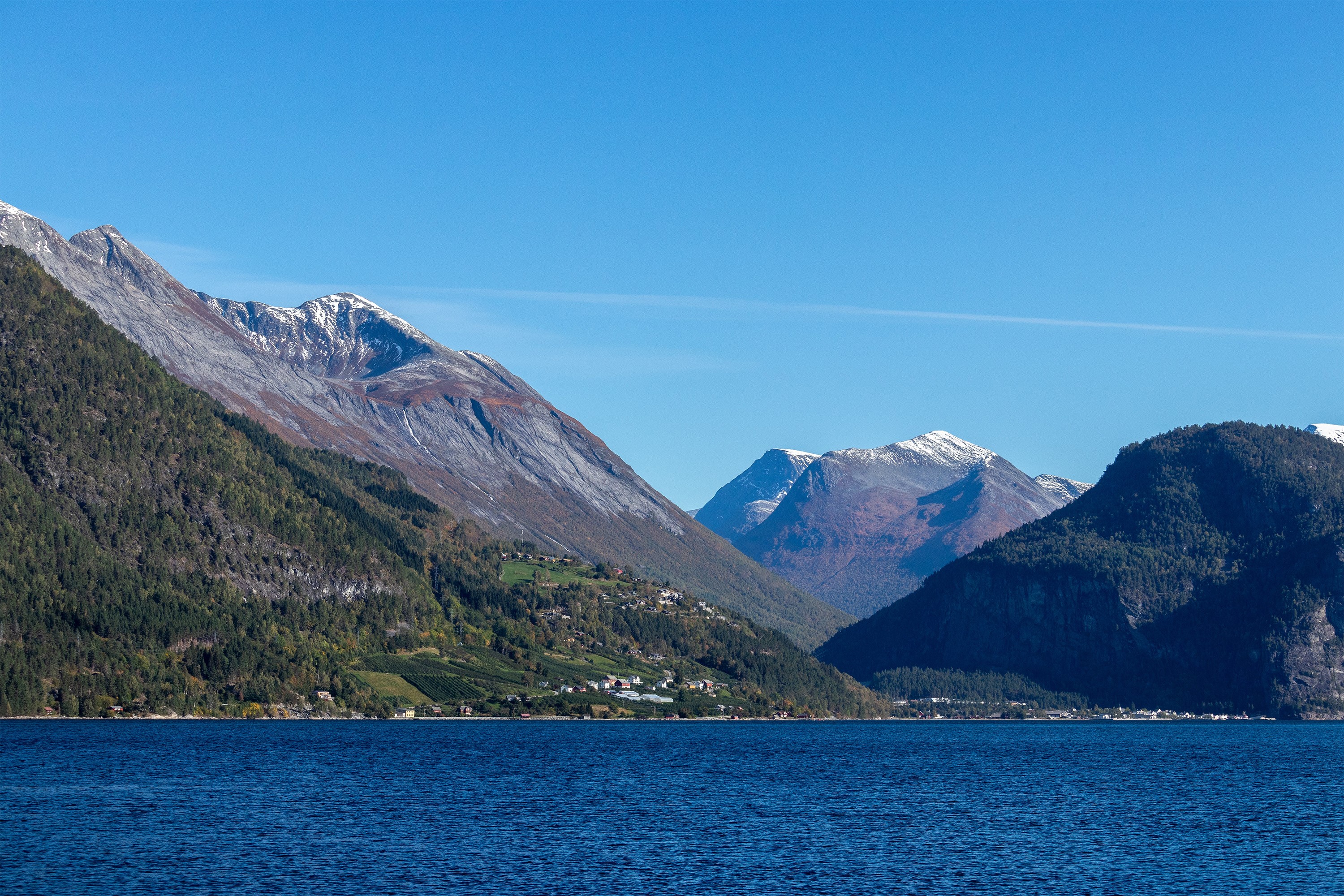 Snow-capped mountains over a blue lake and forest HD Wallpaper
