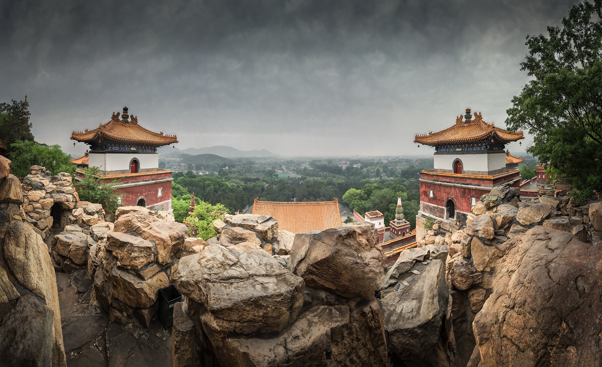 Two pagodas on a rocky hill overlooking a forest in Beijing, China HD Wallpaper