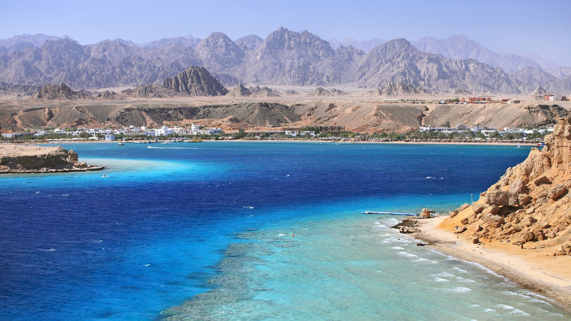 Coastal town with mountains and blue sea HD Wallpaper