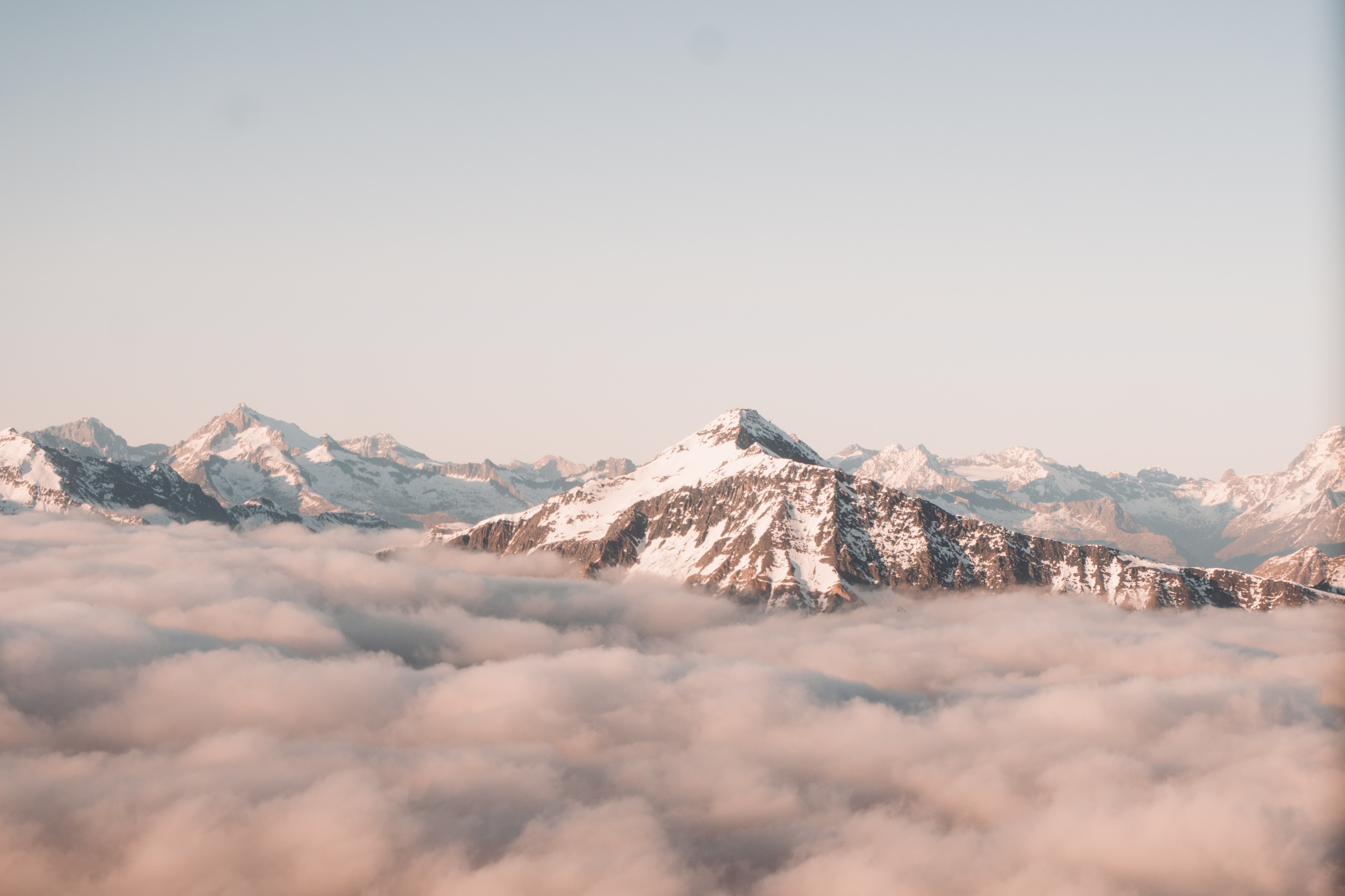 Snowy mountains above clouds HD Wallpaper