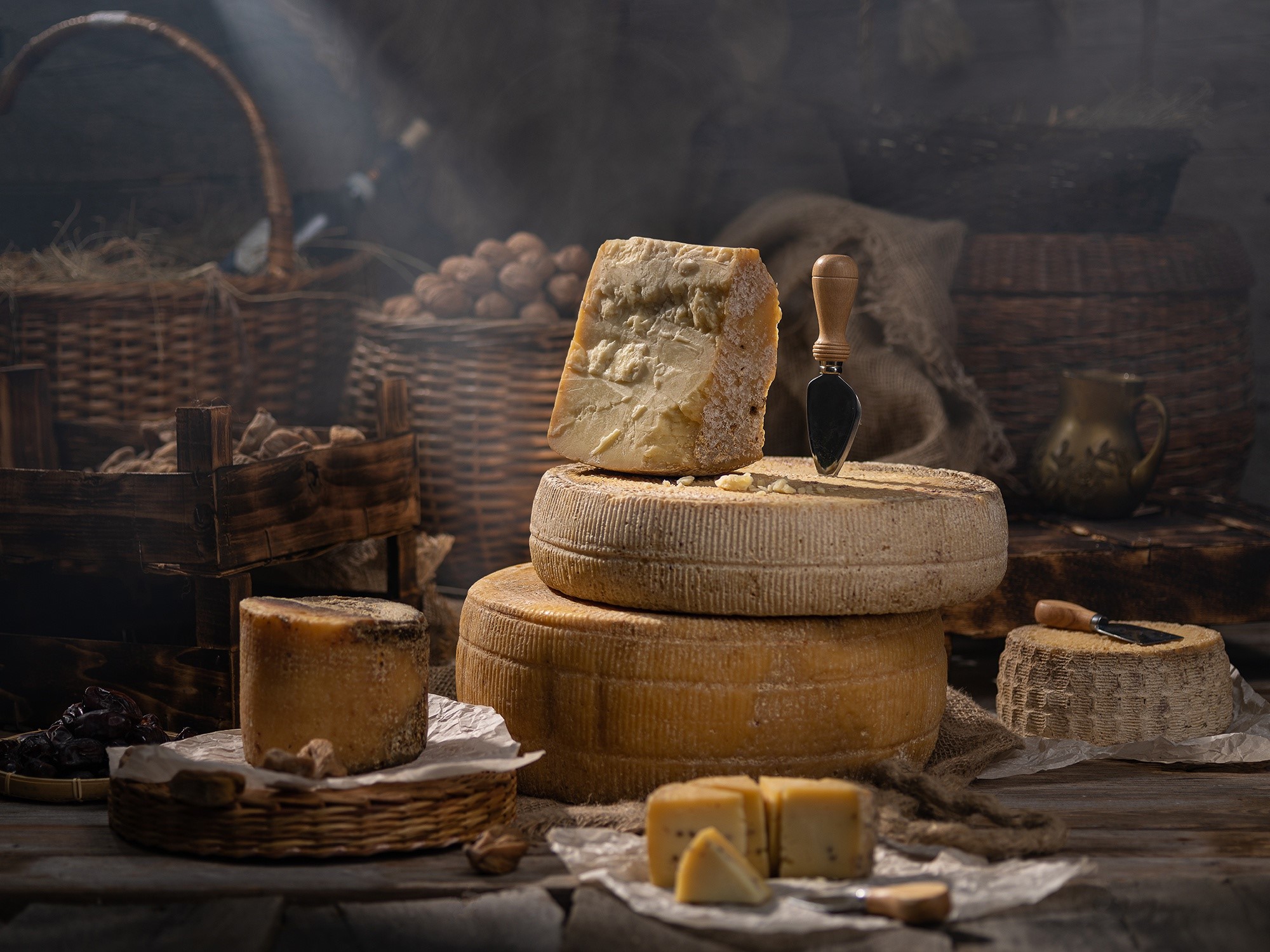 Still life of assorted cheeses in a rustic setting HD Wallpaper