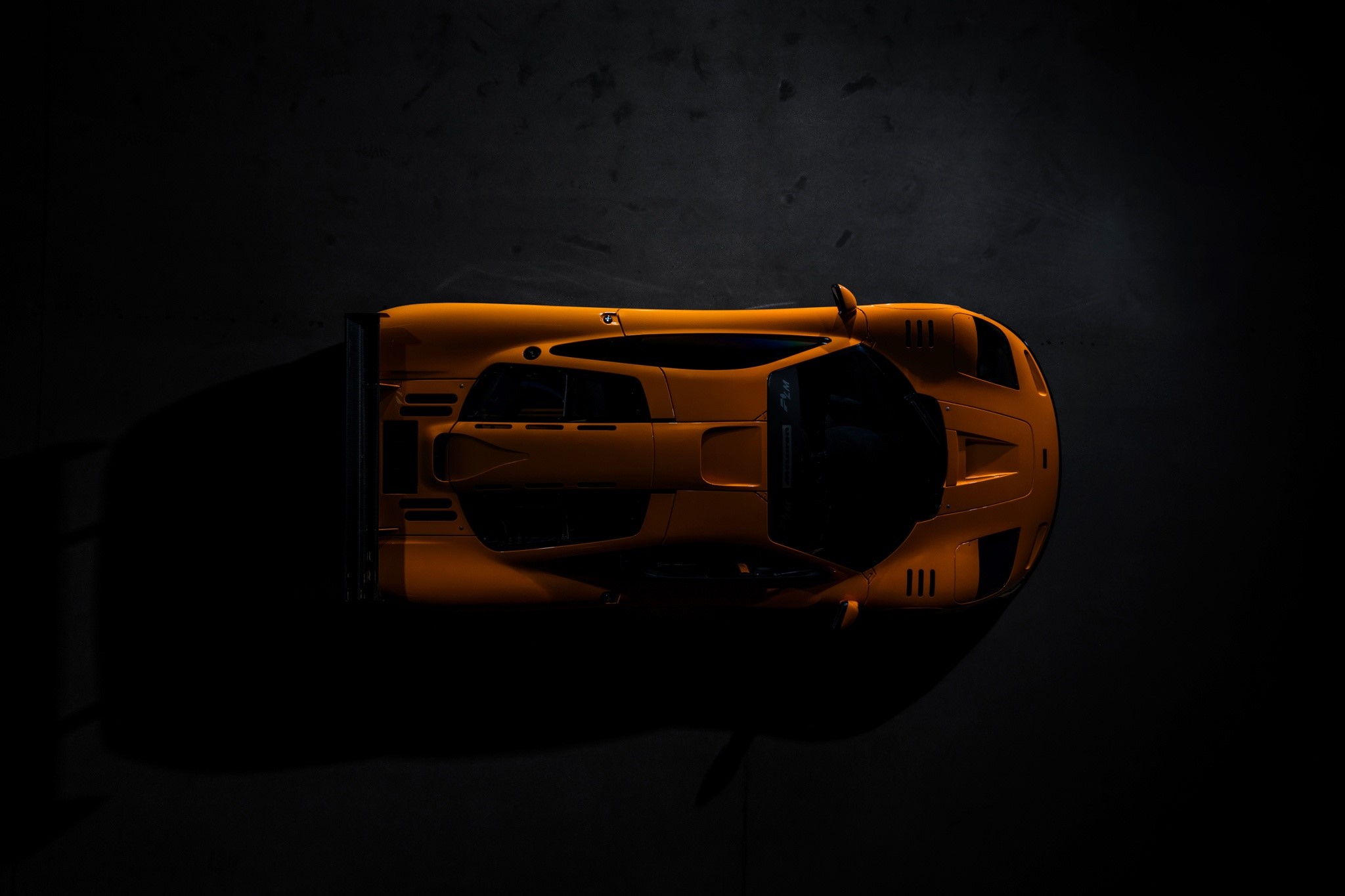 Top view of an orange McLaren F1 LM supercar HD Wallpaper