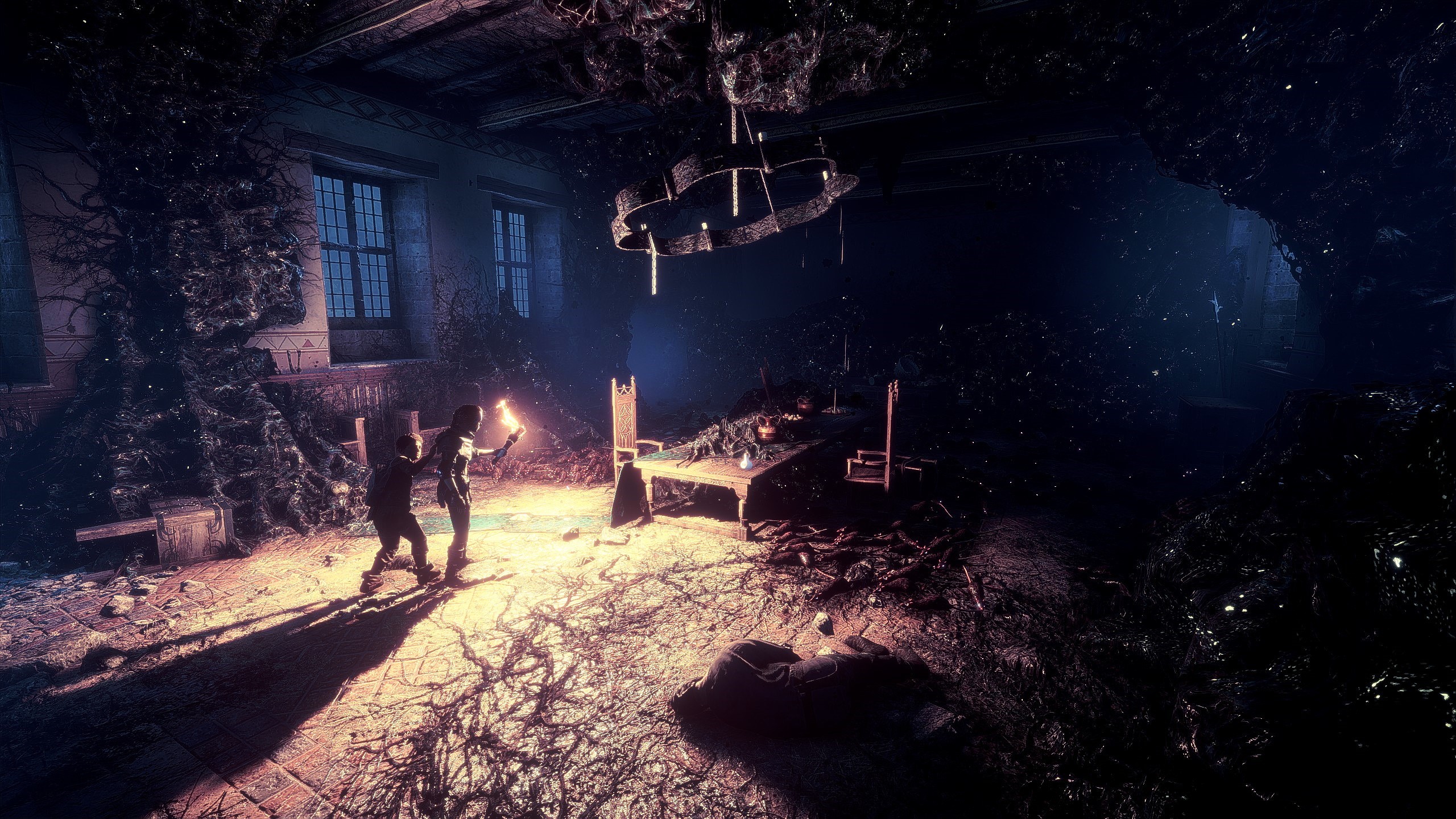 Two people with torches in a dark, vine-covered room HD Wallpaper