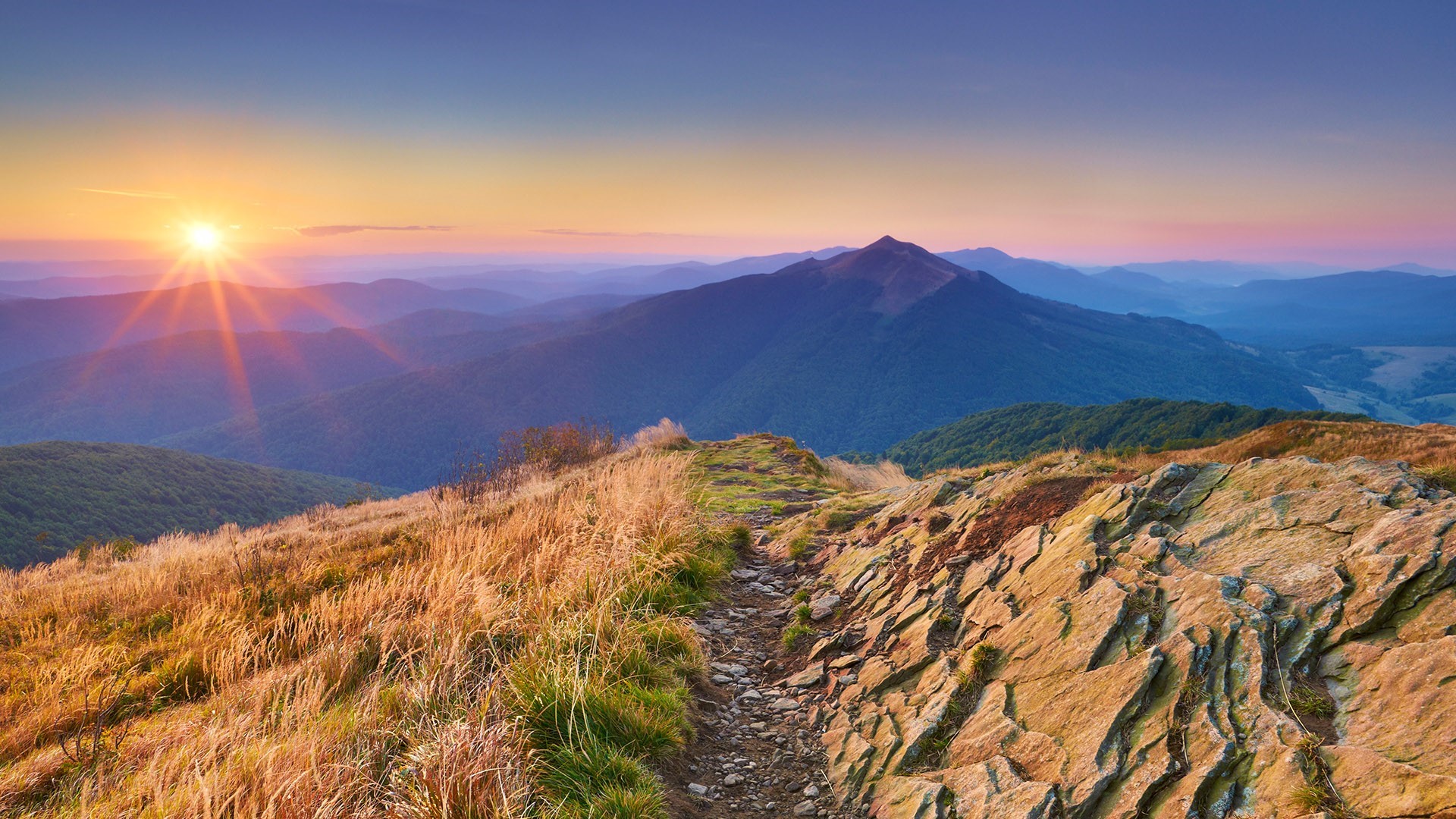 Sunrise over mountain range with rocky path HD Wallpaper