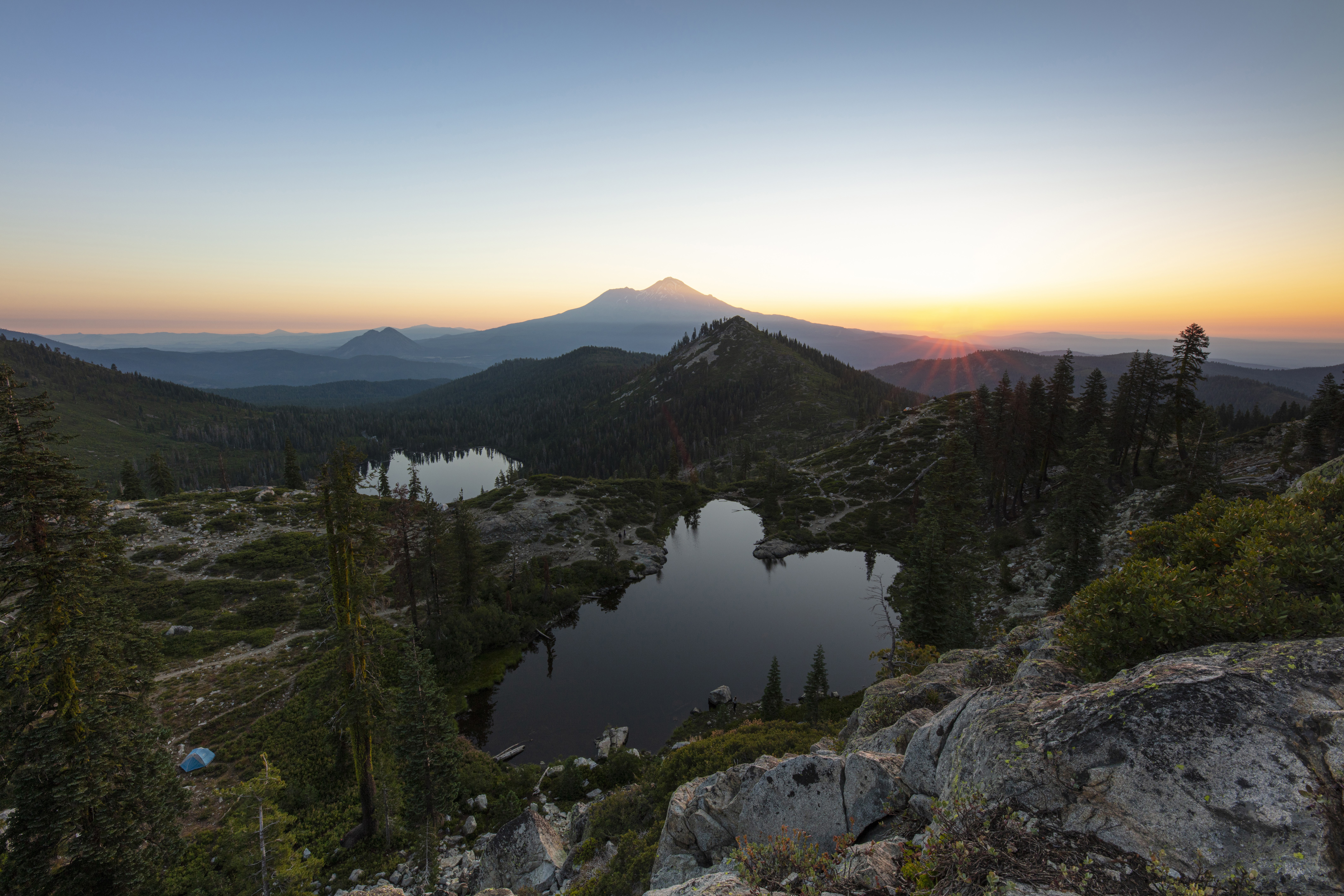 Sunset over mountain lakes with trees and rocks HD Wallpaper