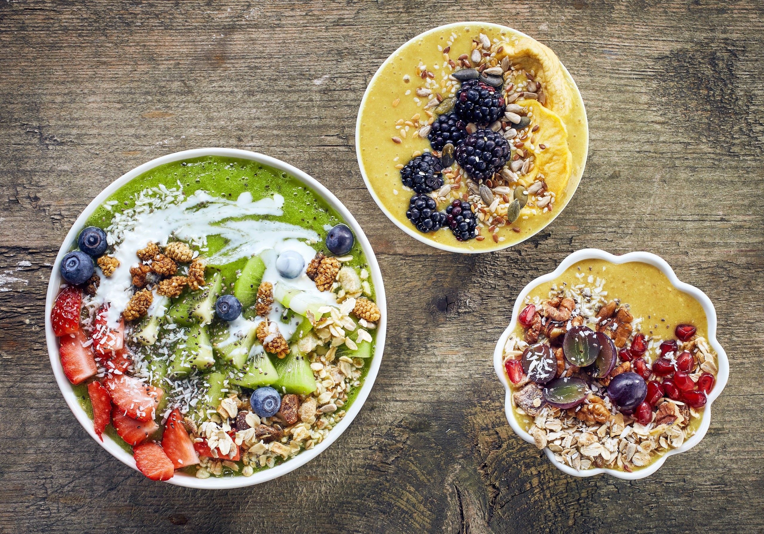 Three smoothie bowls with fruits and granola HD Wallpaper
