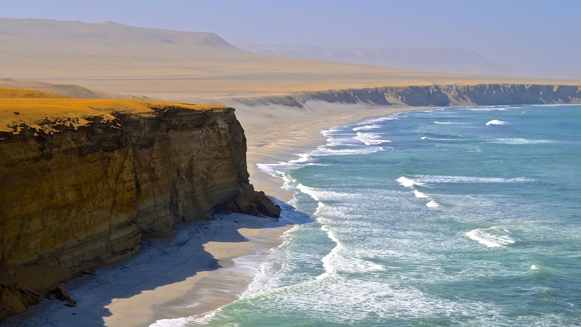 Coastal cliffs and desert landscape meeting the ocean HD Wallpaper