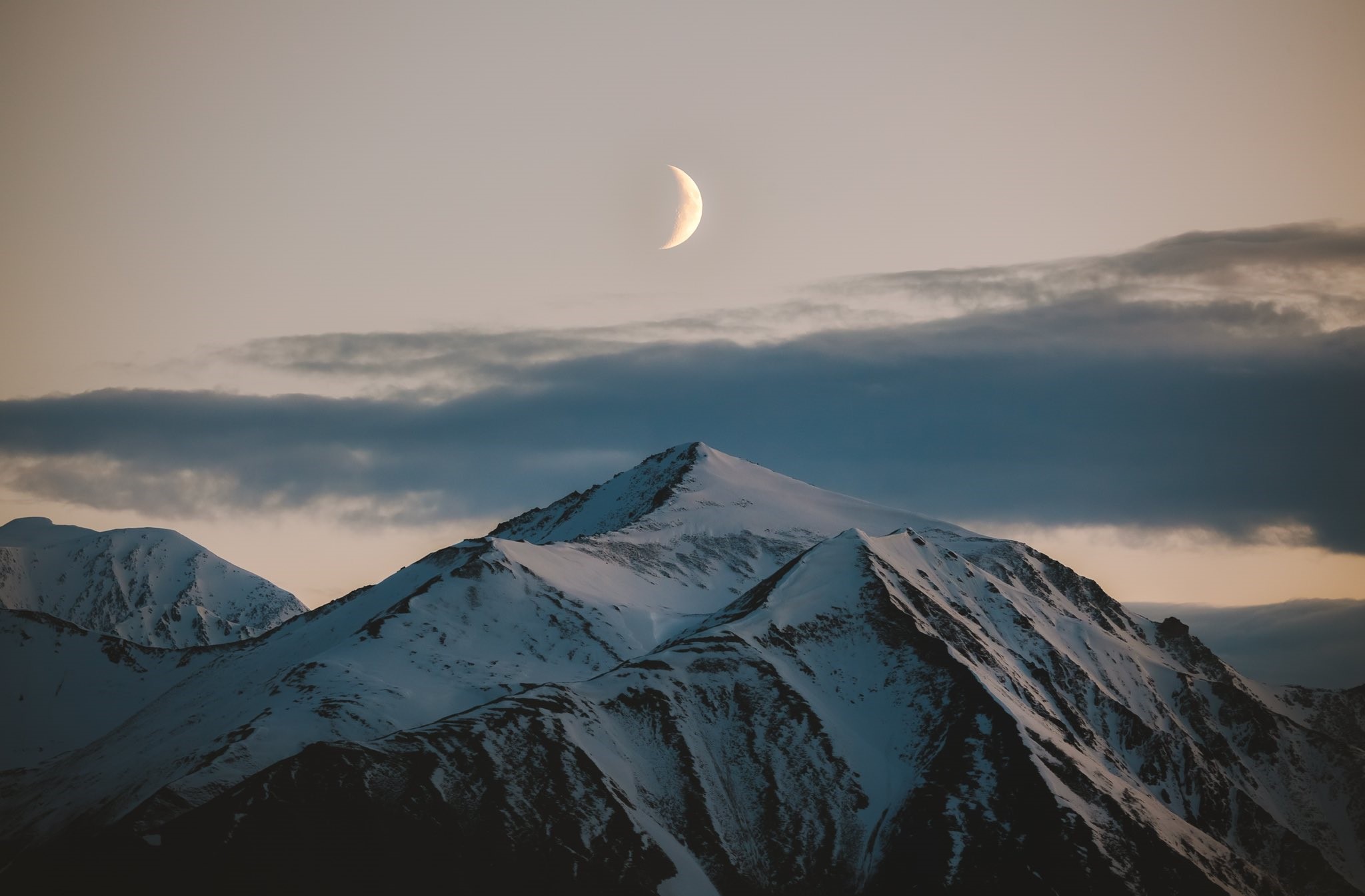 Crescent moon over snowy mountains at dusk HD Wallpaper