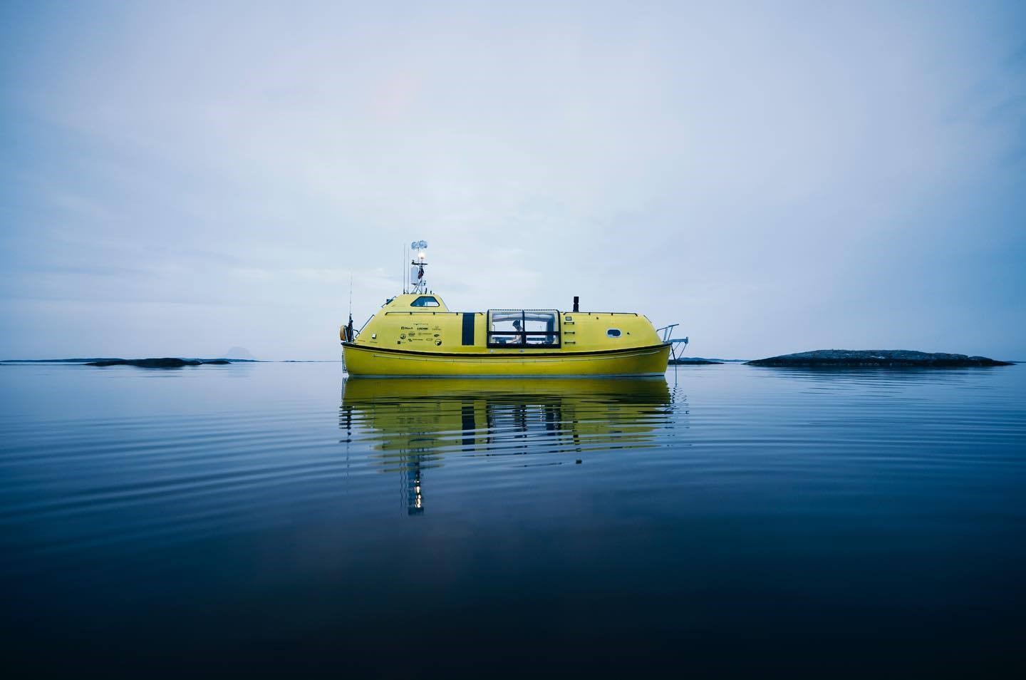 Yellow boat on calm water with islands HD Wallpaper
