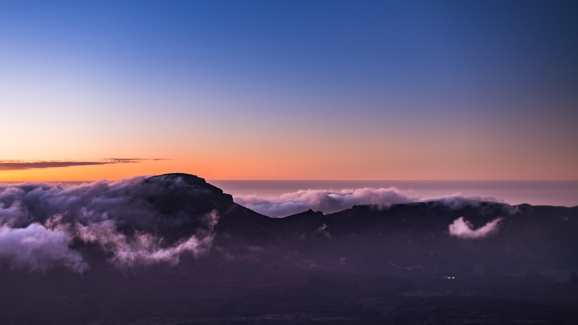 Sunset over mountains with clouds HD Wallpaper