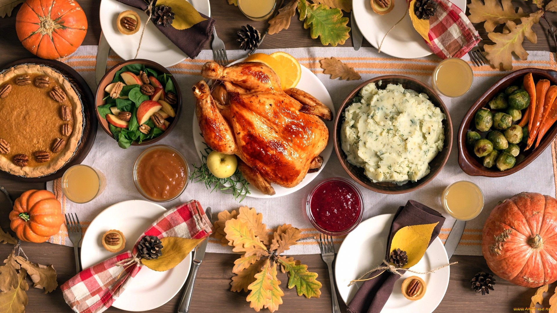 Thanksgiving dinner with roasted chicken, pies, and side dishes HD Wallpaper