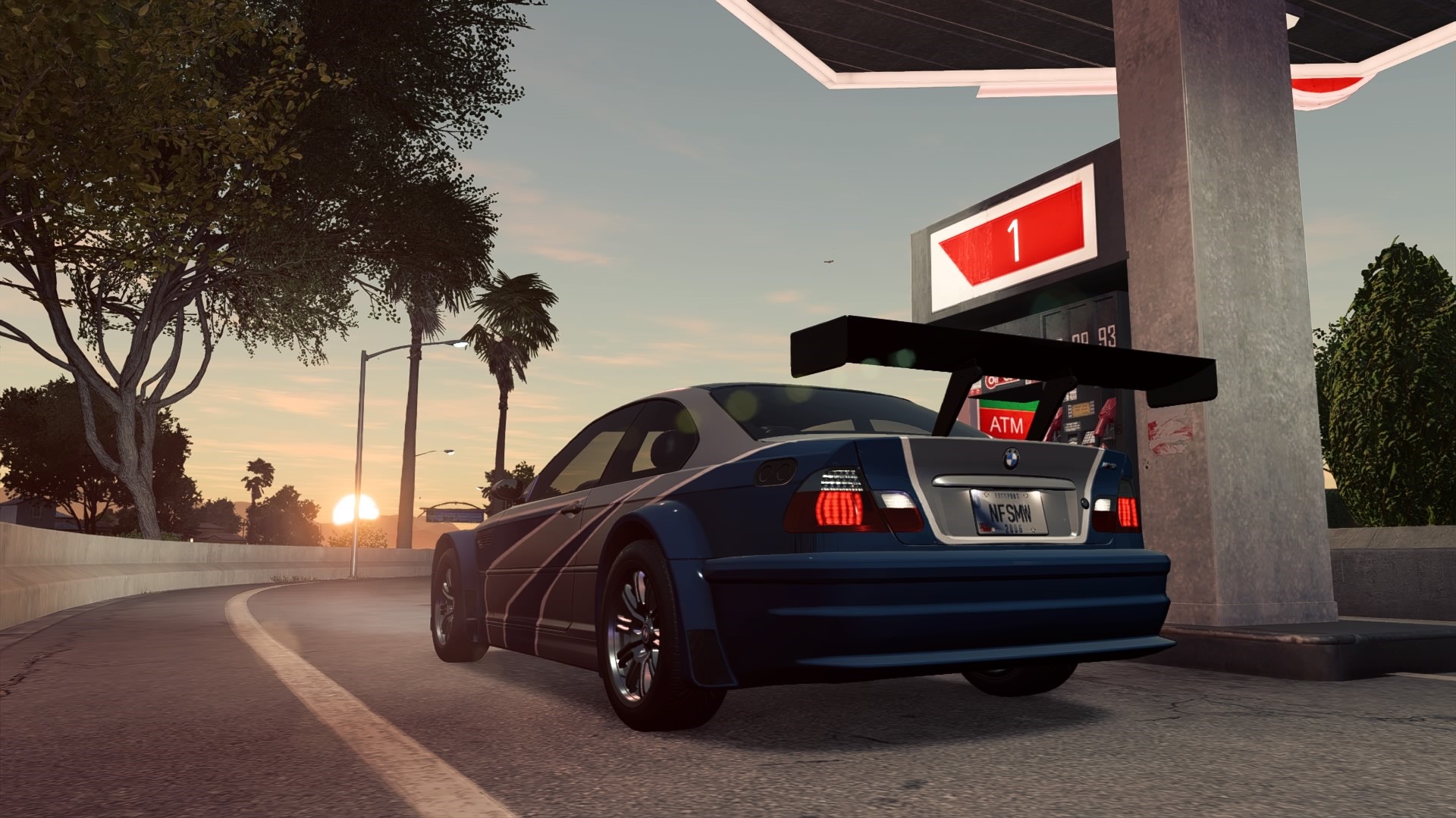 BMW M3 GTR at a gas station during sunset HD Wallpaper