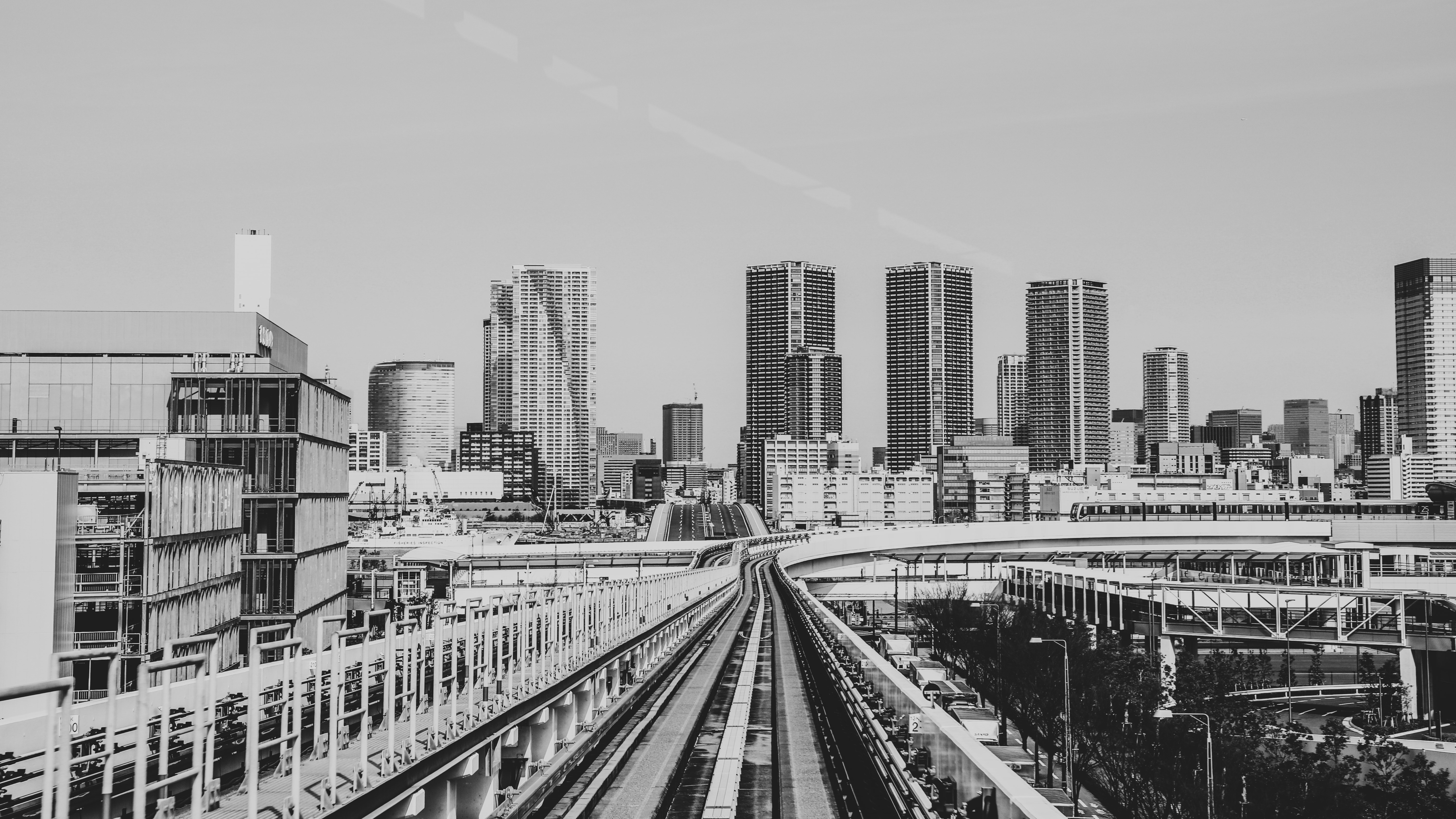 4K Tokyo urban street with skyscrapers and train tracks HD Wallpaper