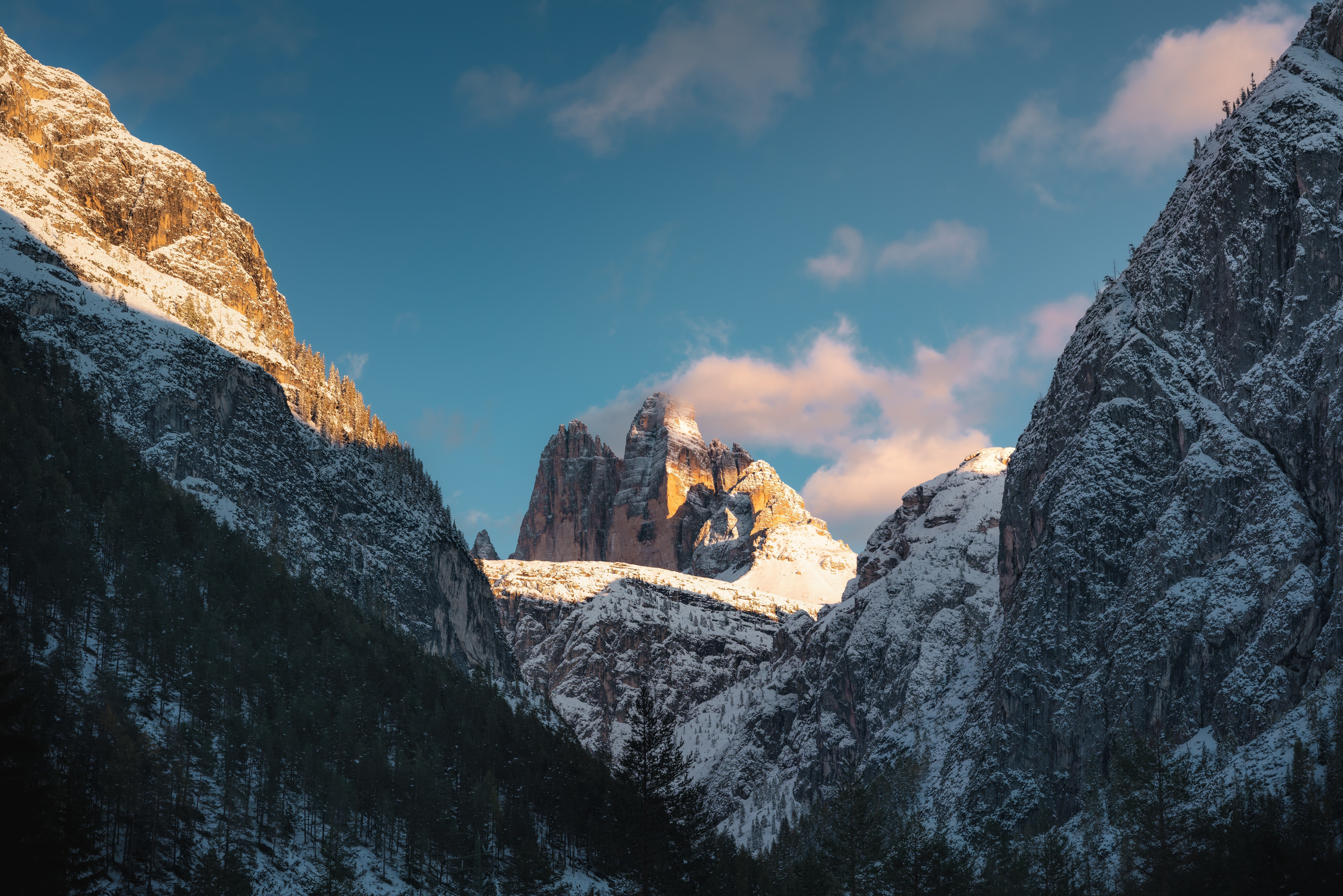 Snowy mountains with trees and clouds HD Wallpaper