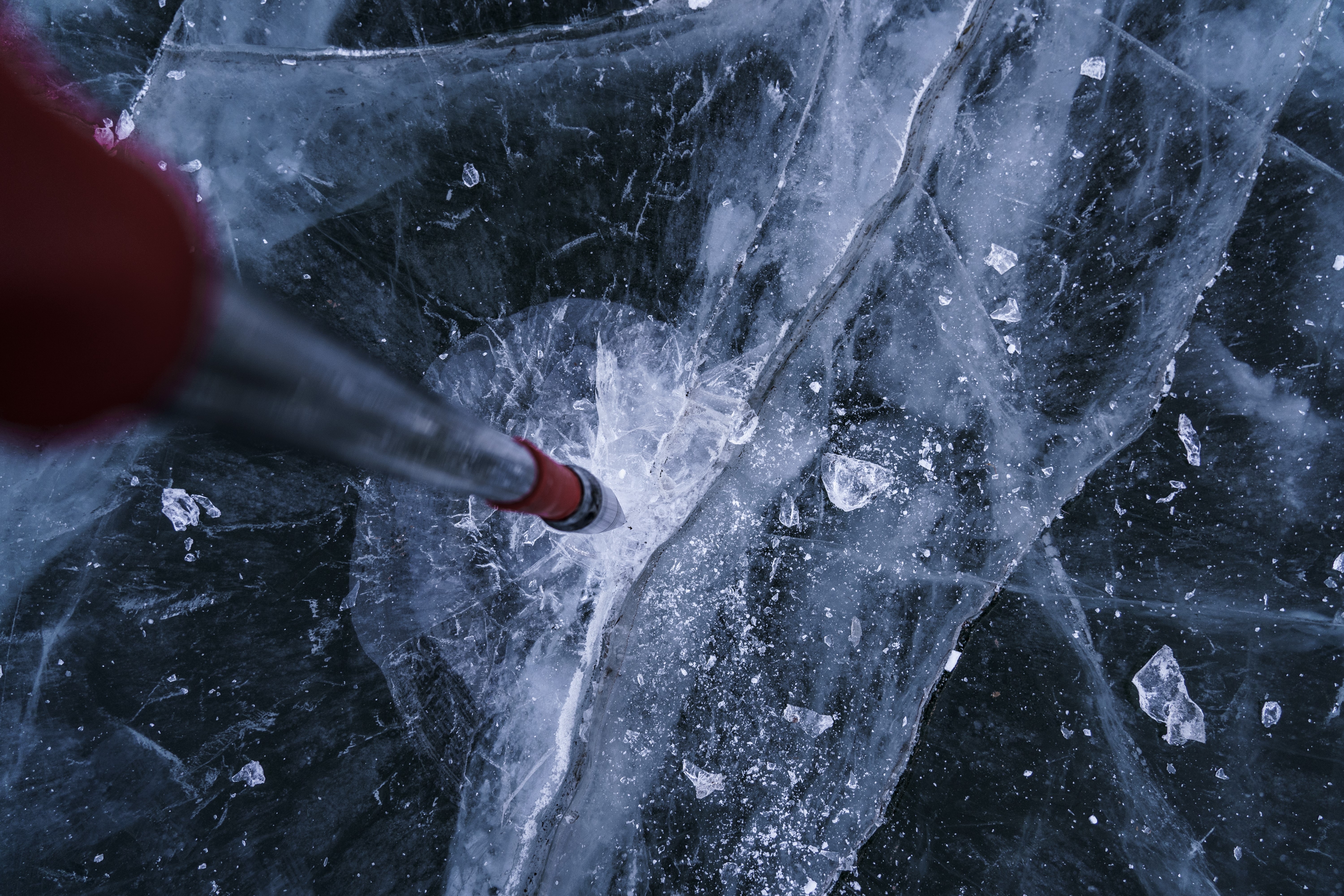 Drilling a hole in a frozen lake HD Wallpaper