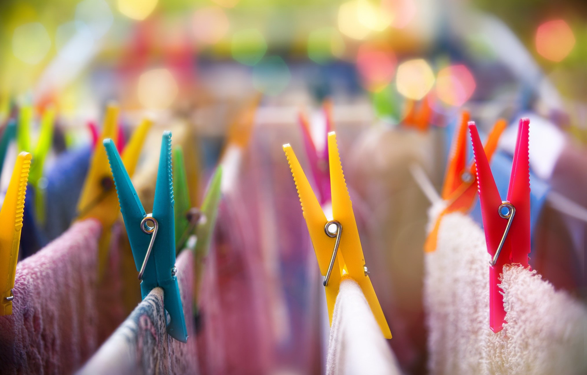 Colorful clothespins on a laundry line with bokeh HD Wallpaper