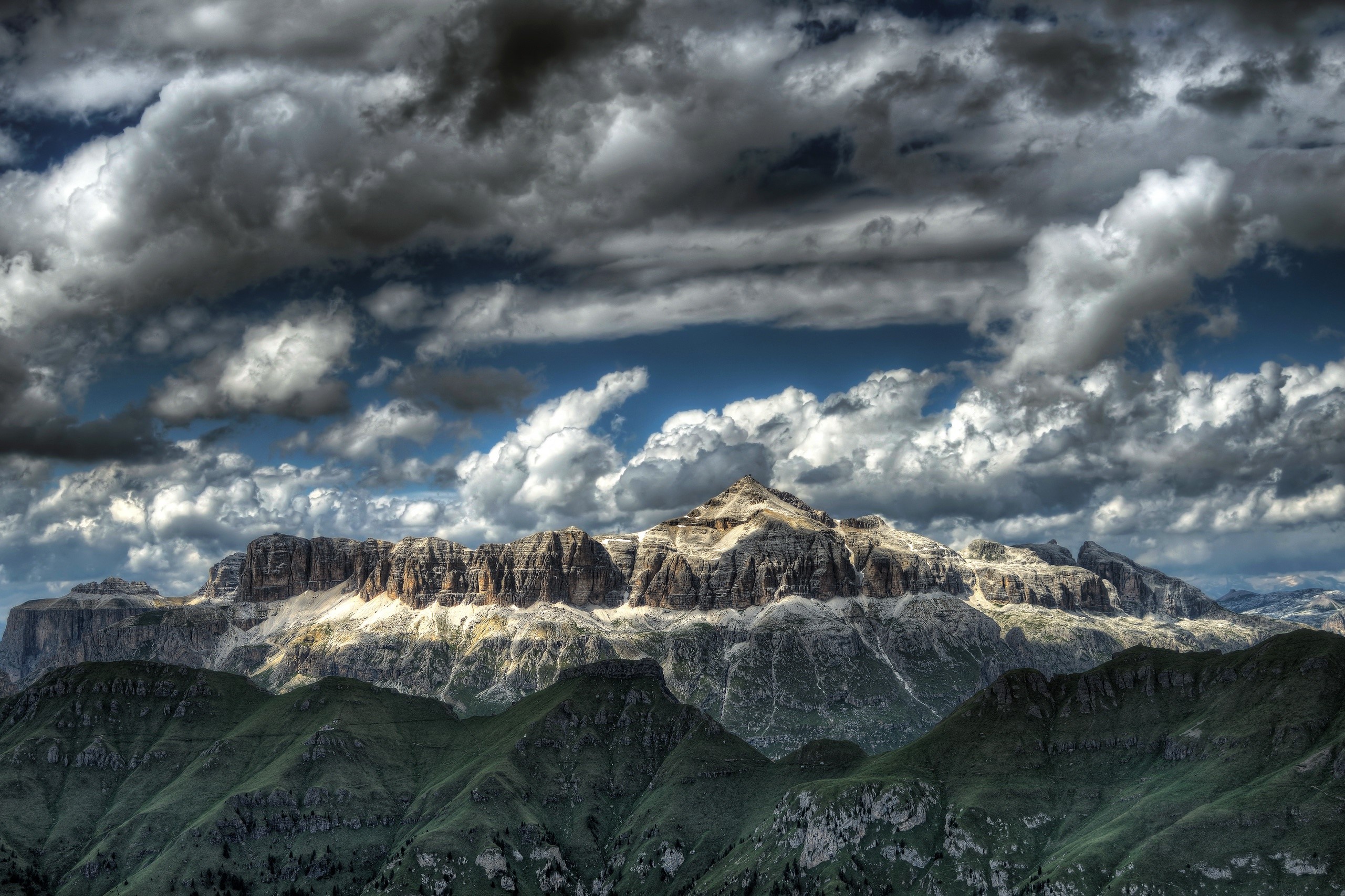 Dramatic mountain range under stormy clouds in Italy HD Wallpaper