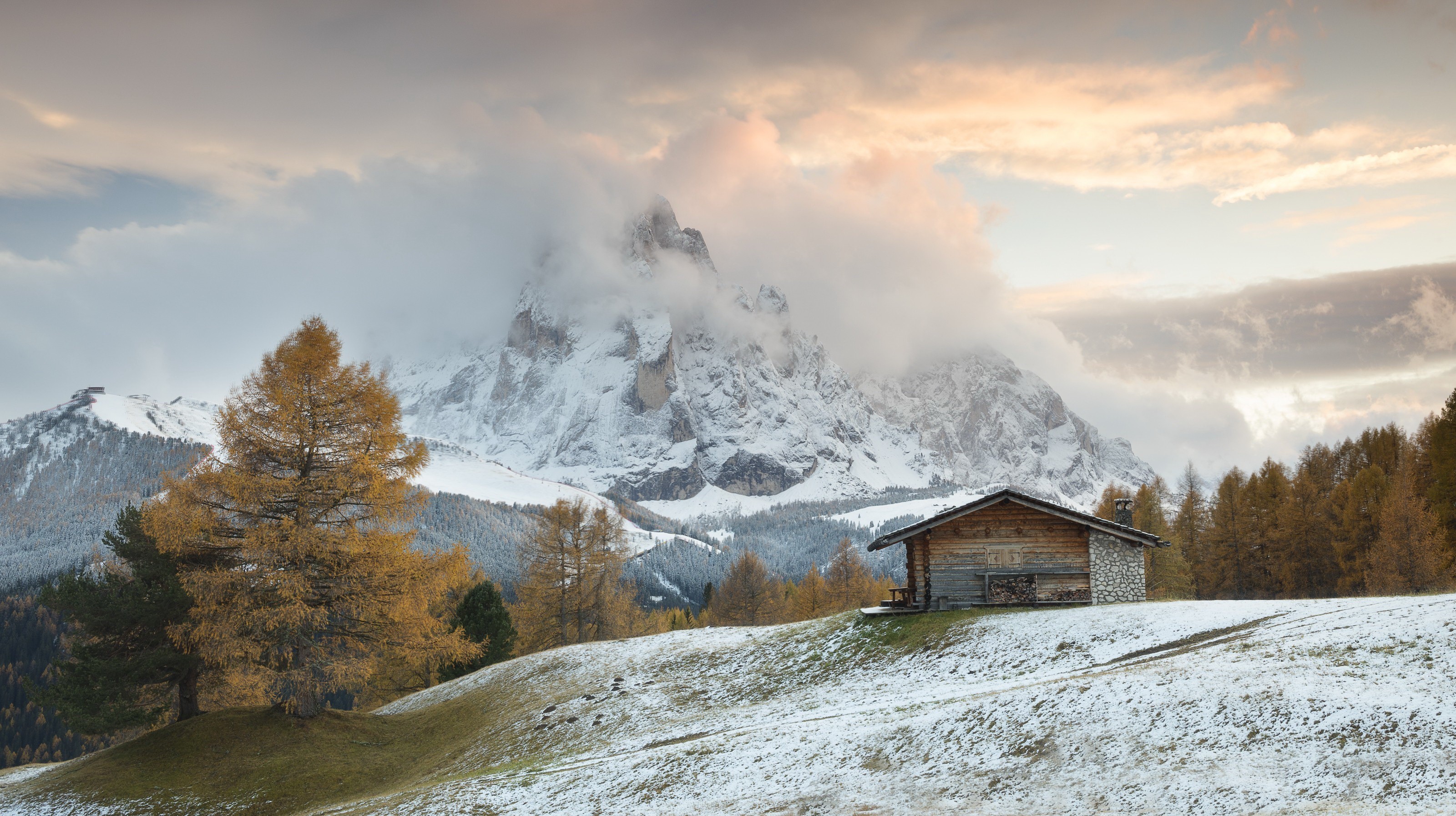 Wooden hut on a snowy mountain slope with autumn trees HD Wallpaper