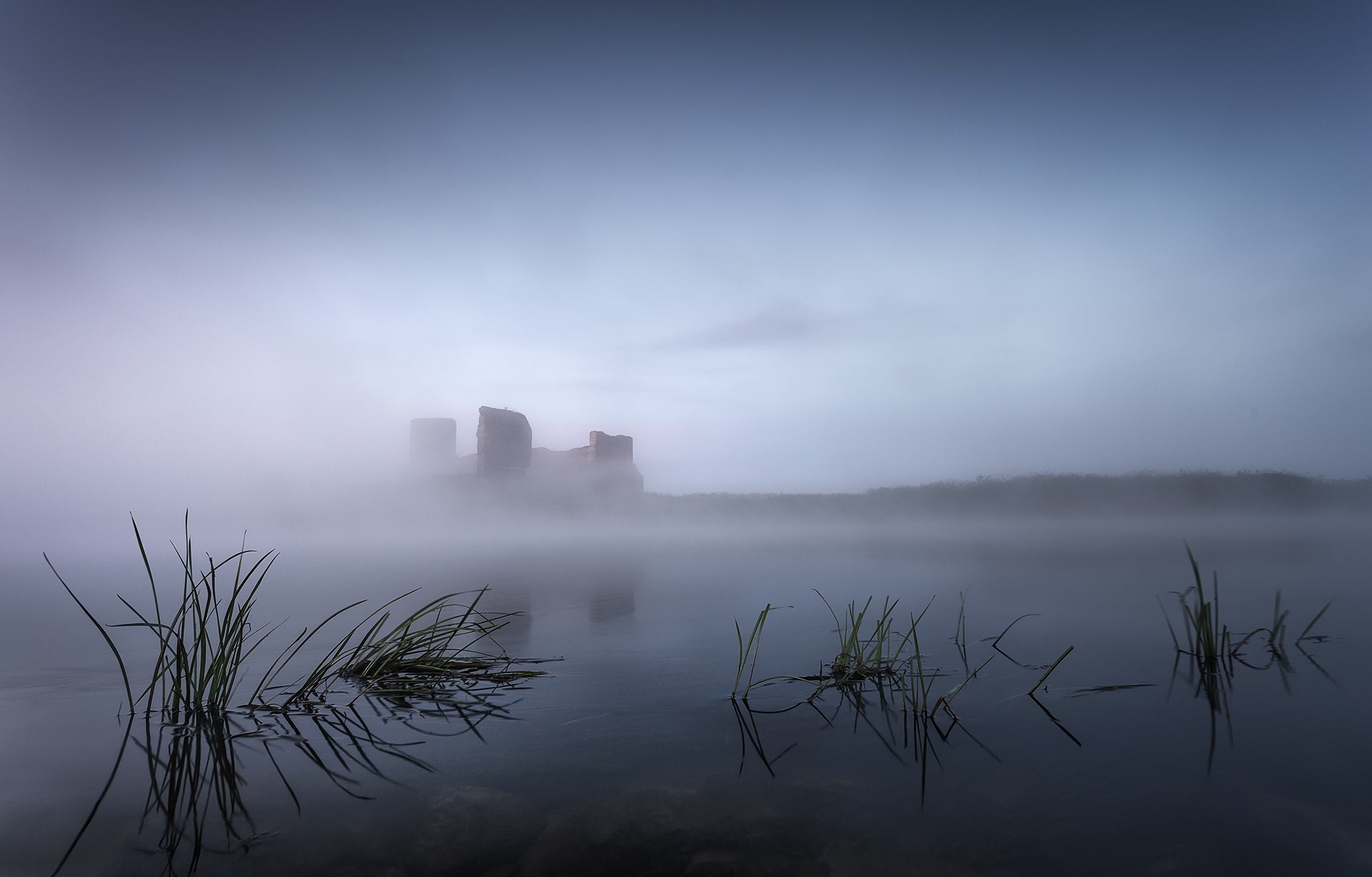 Misty morning over lake with castle ruins HD Wallpaper