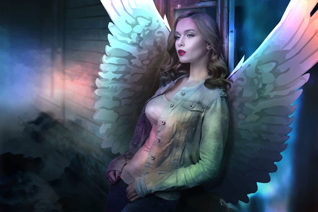 Woman with angel wings leaning against a wall HD Wallpaper