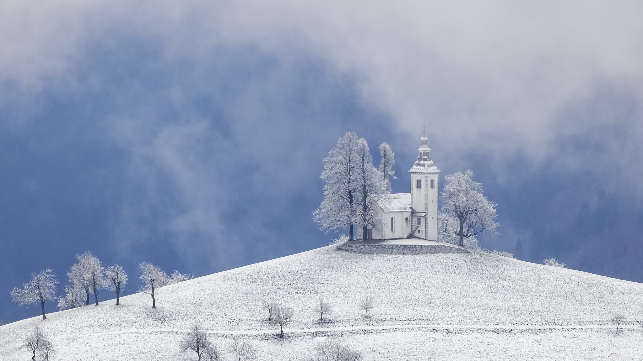 Church in Slovenia covered in snow during winter HD Wallpaper