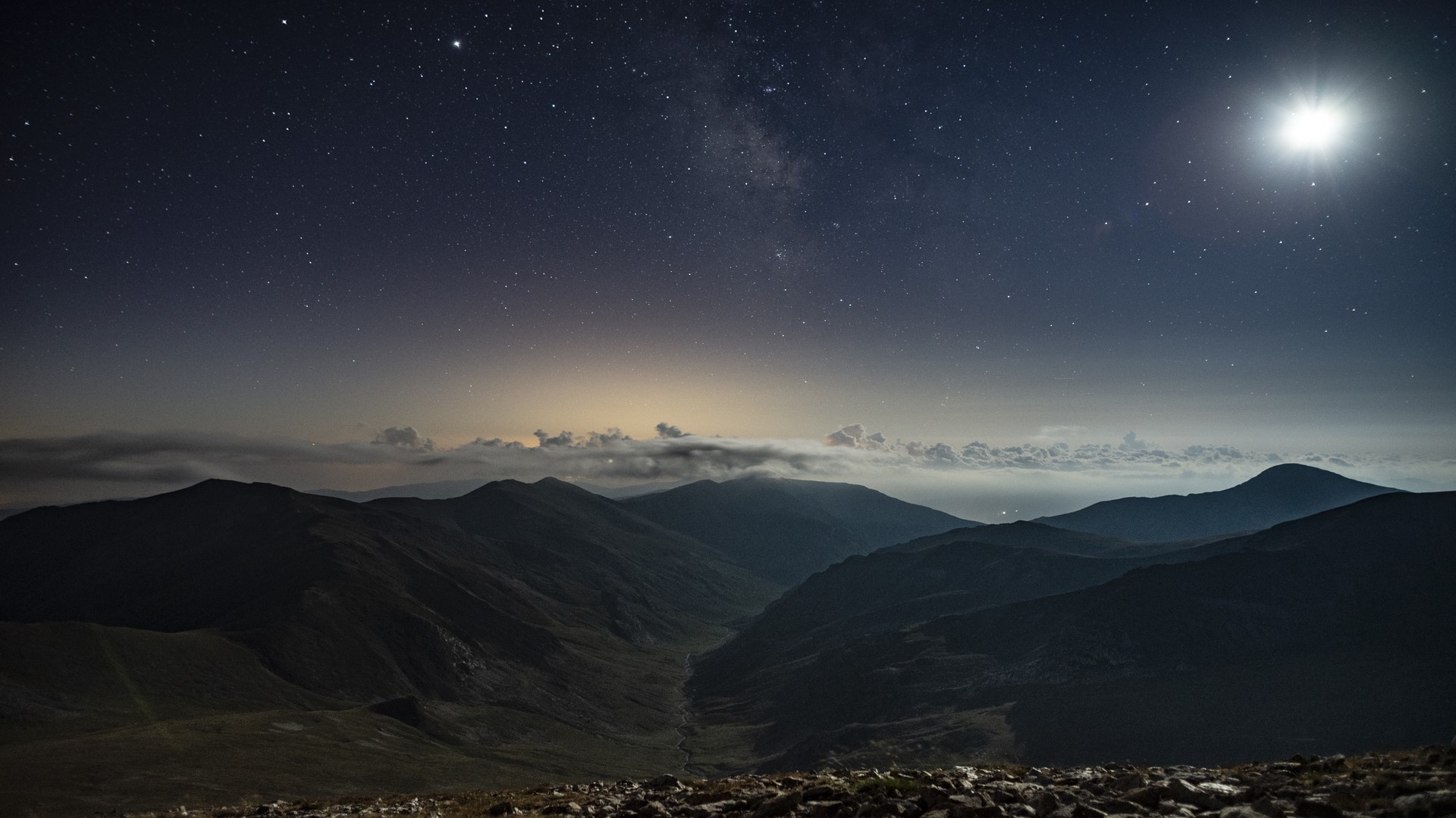 Mountains under starry sky with moon and clouds HD Wallpaper