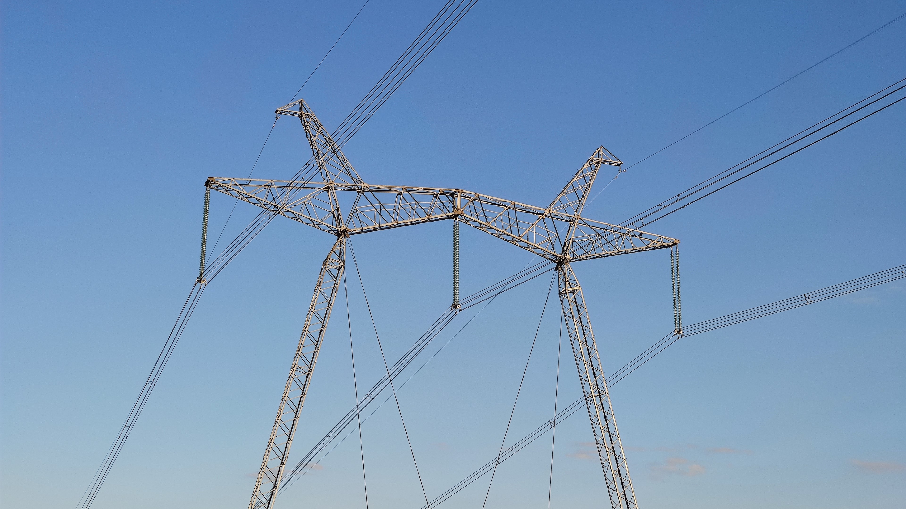 Power lines against a clear blue sky HD Wallpaper