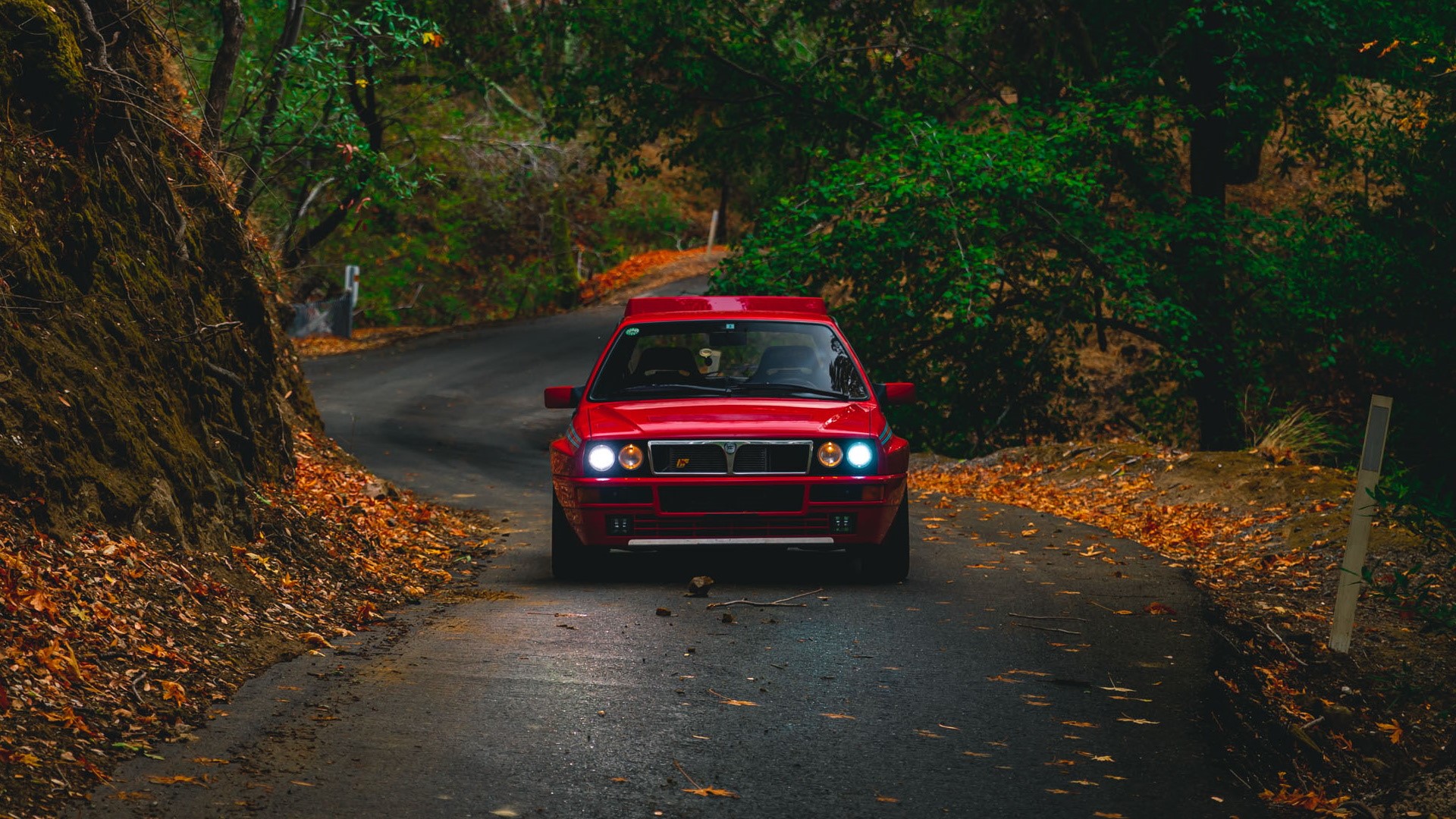 Red Lancia Delta Integrale on a winding road HD Wallpaper