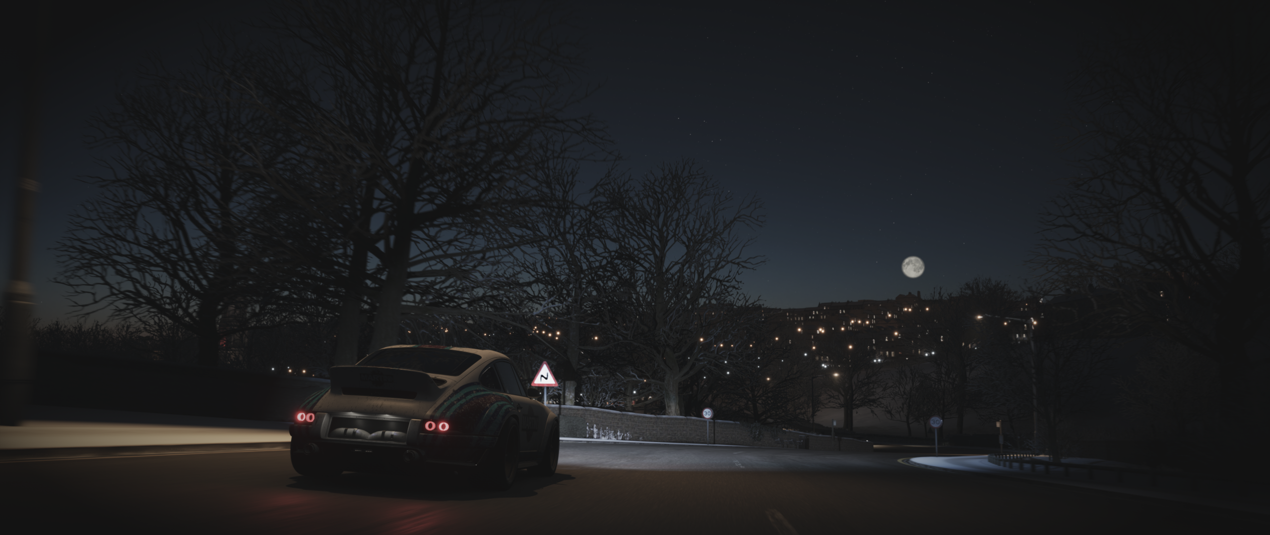 Porsche driving on a snowy road at night HD Wallpaper